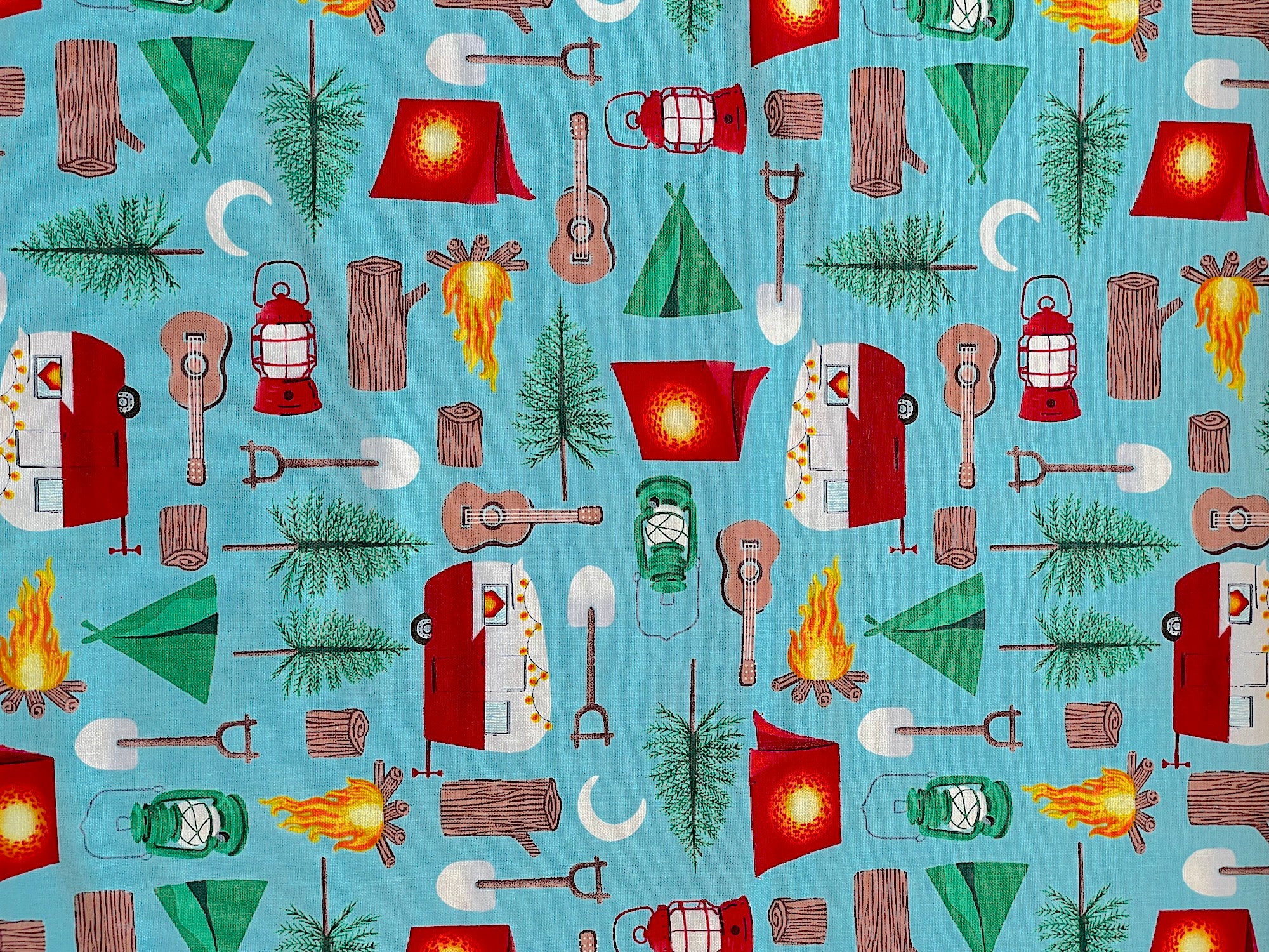 Cotton fabric covered with travel trailers, tents, trees, guitars and more.