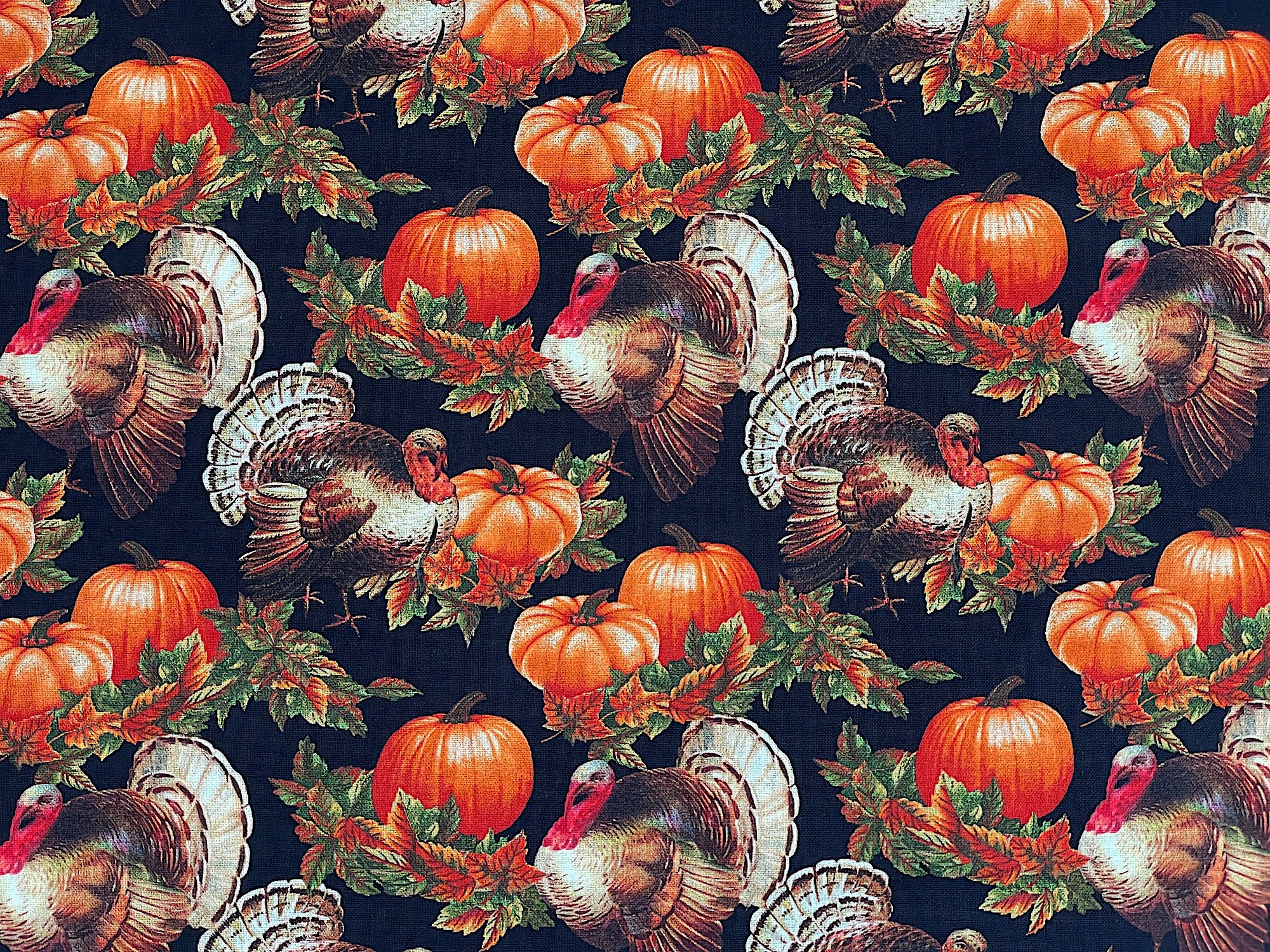 Cotton fabric covered with turkeys and pumpkins.