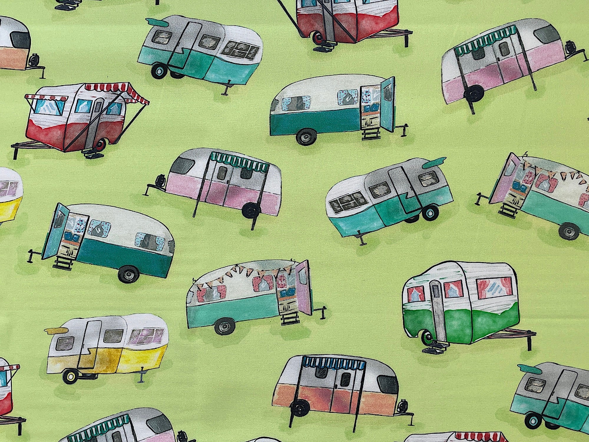 This green cotton fabric is part of the Happy Campers collection.  This cotton fabric is covered with travel trailers.