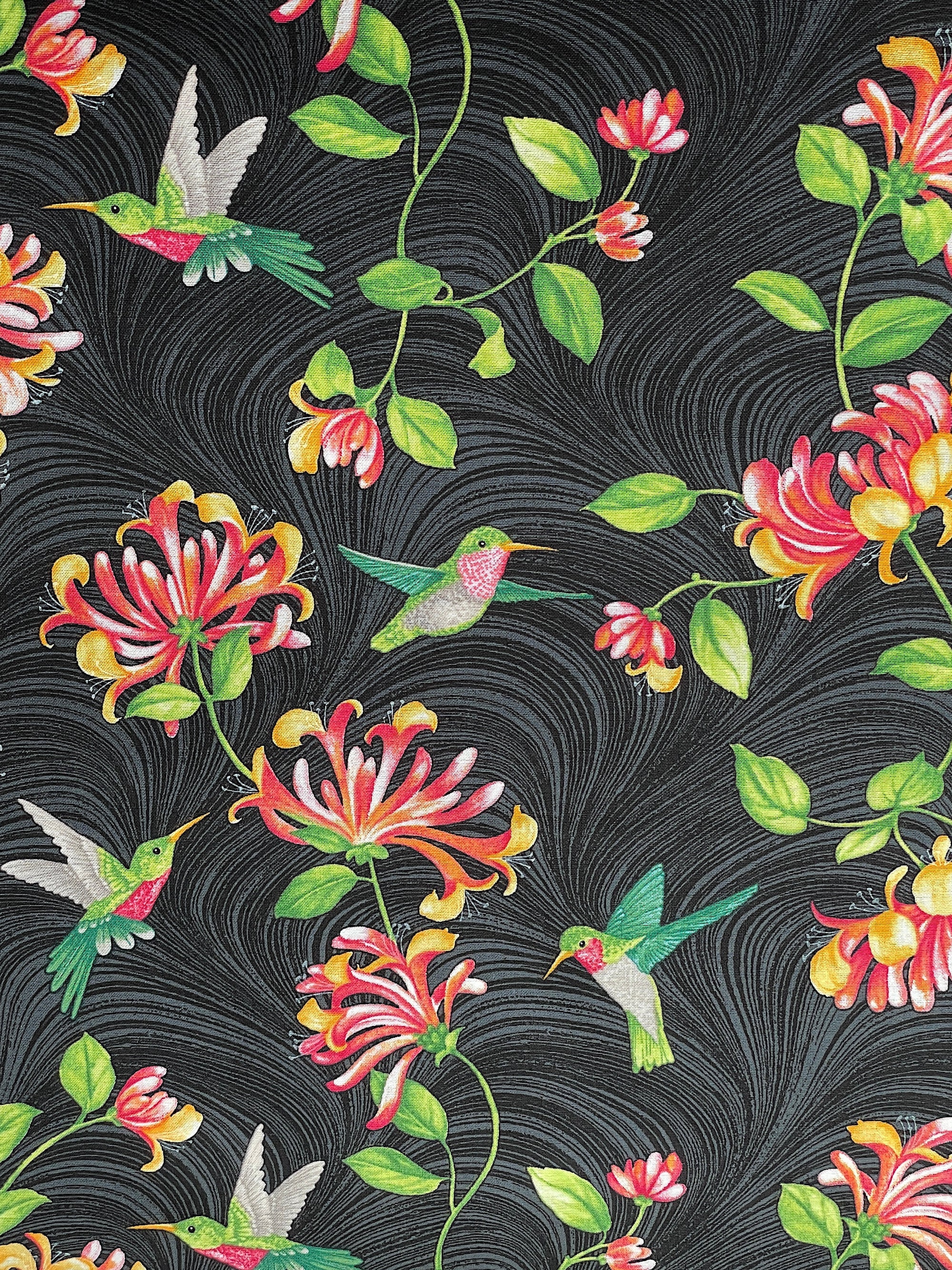 Black cotton fabric covered with hummingbirds and flowers.