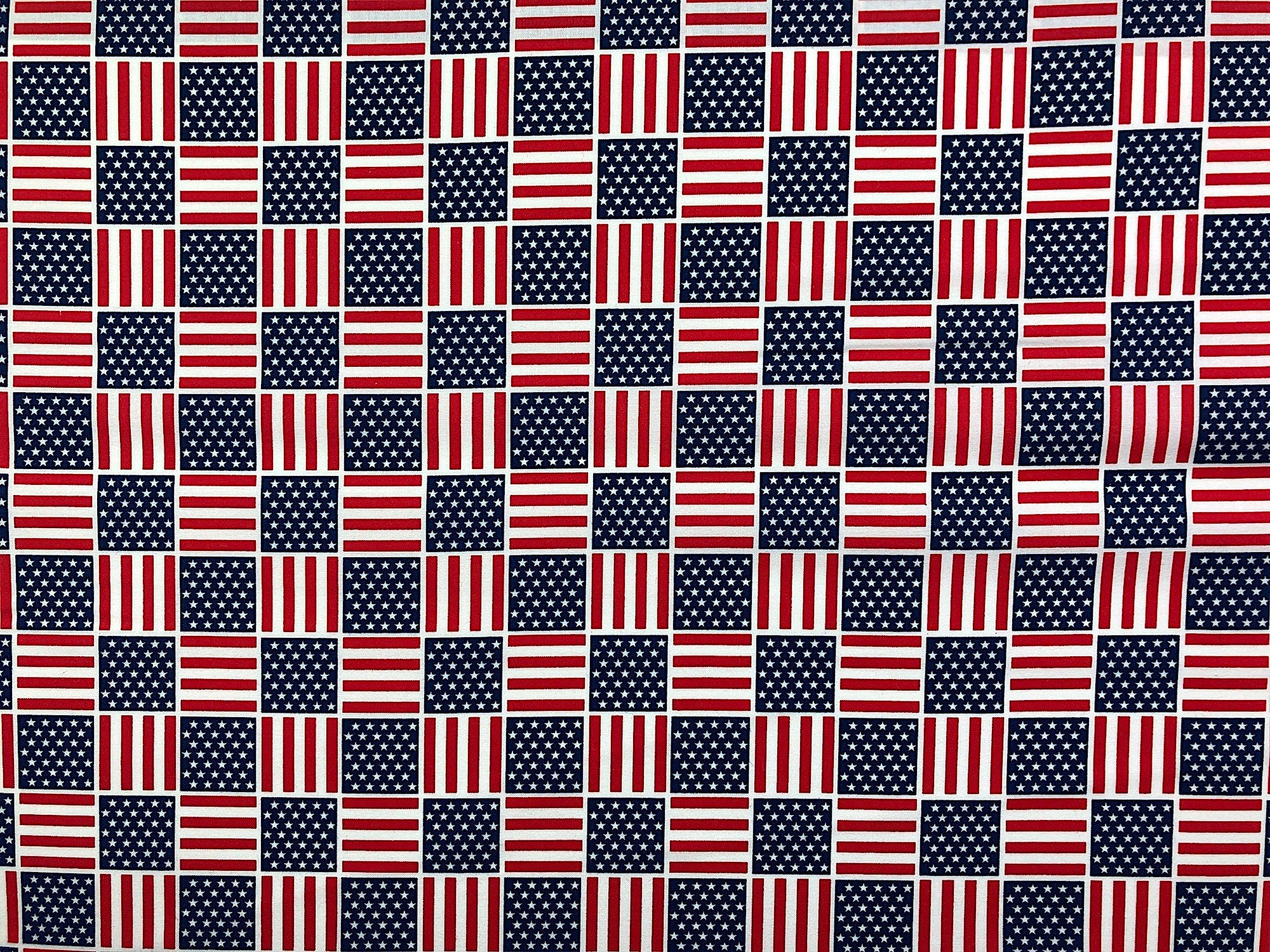 This fabric is covered with flags arranged in a checkered pattern.