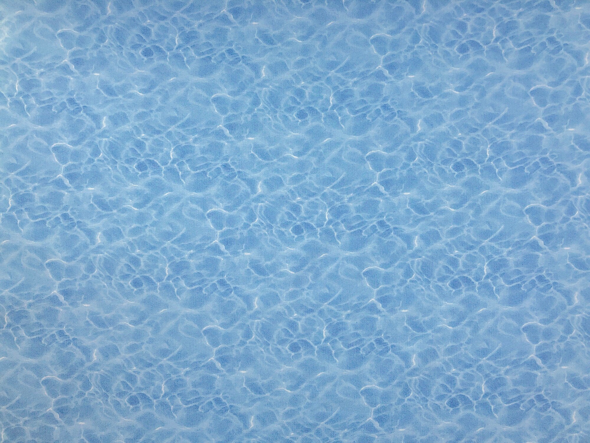 This fabric is as if you are looking into a swimming pool. This cotton fabric is blue and white.