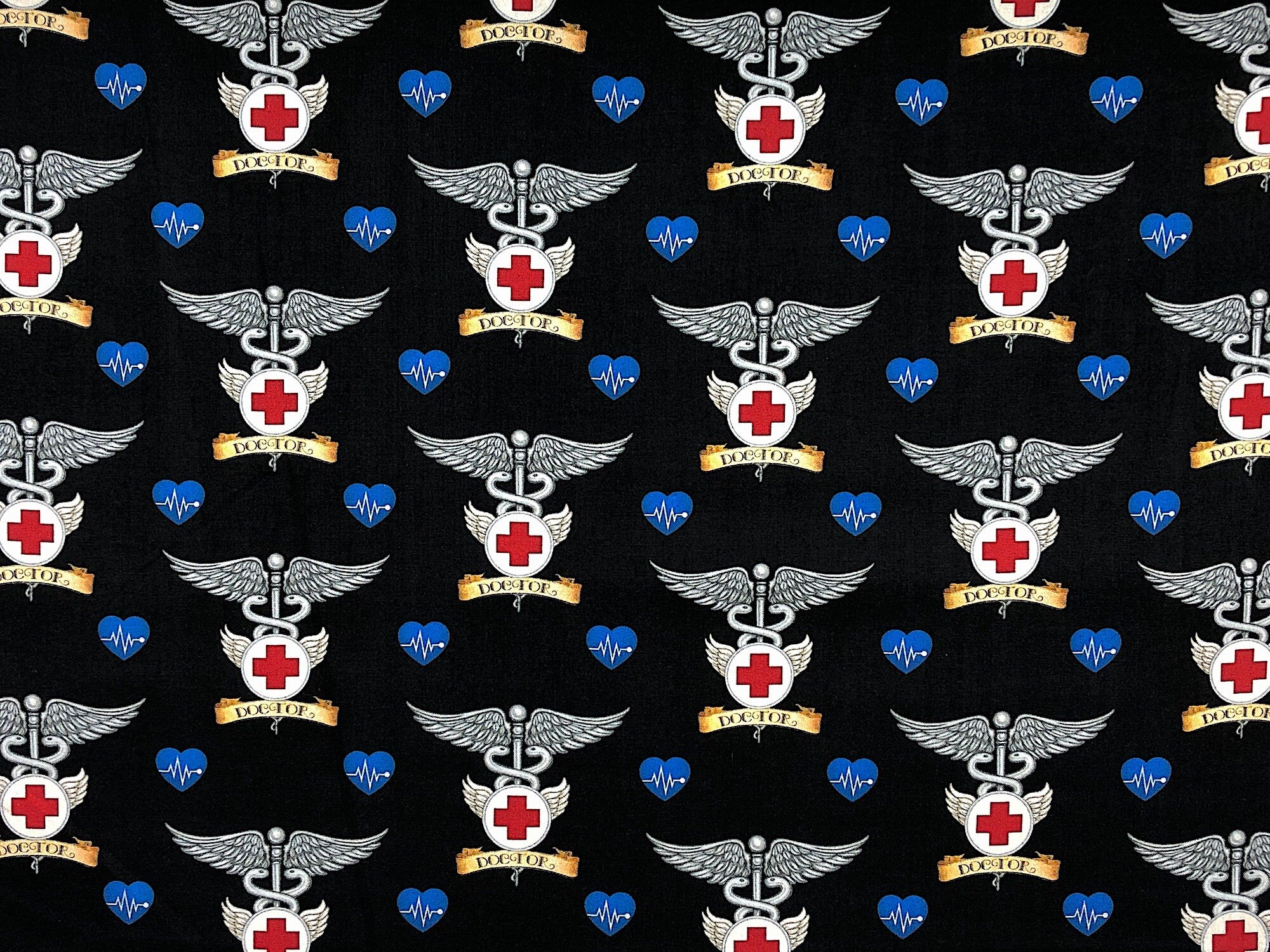This black fabric is covered with doctor symbols. This fabric is part of the What the Doctor Ordered collection by QT Fabrics.