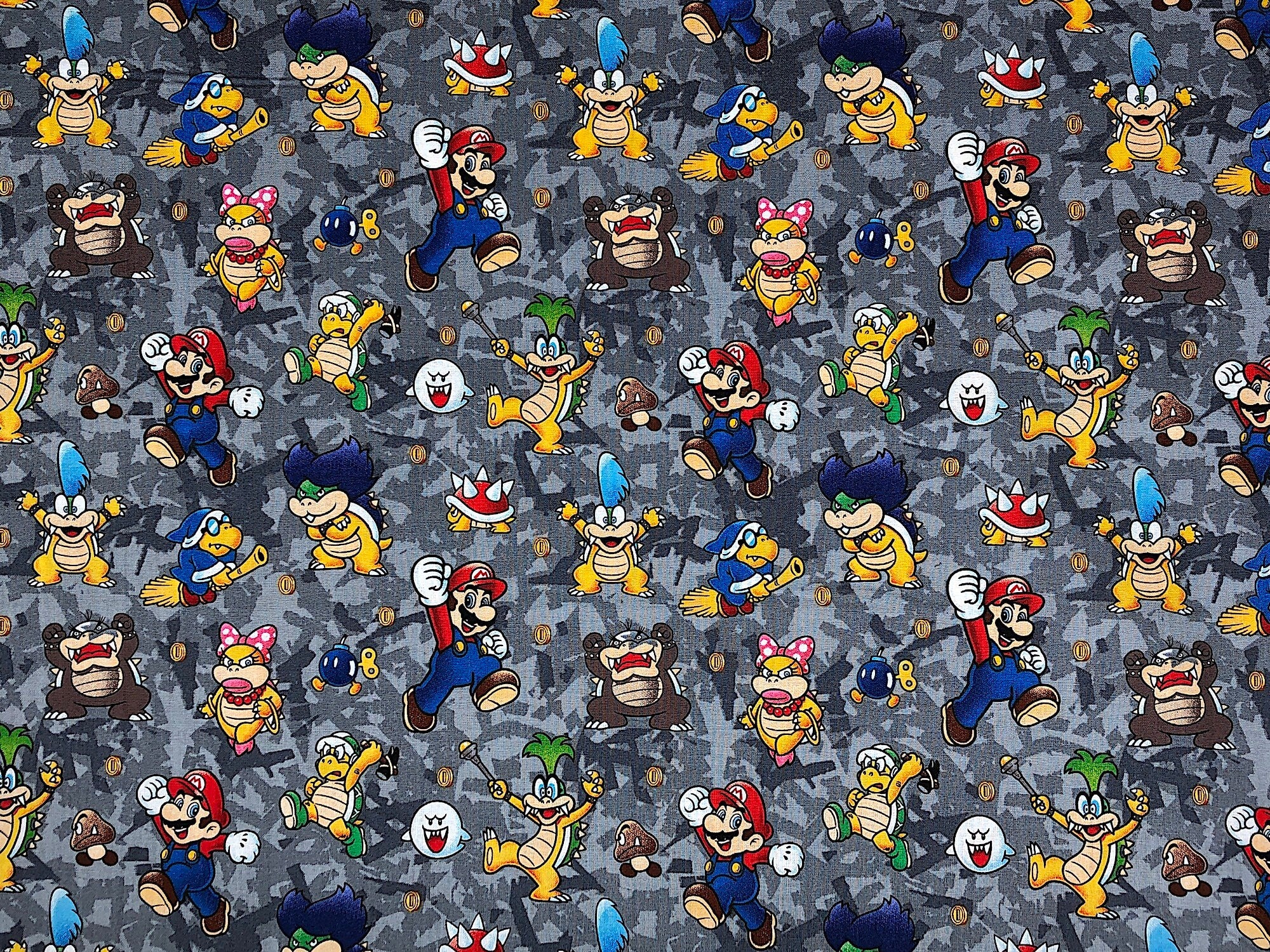 This gray fabric is covered with Super Mario characters such as Mario and Bowser.