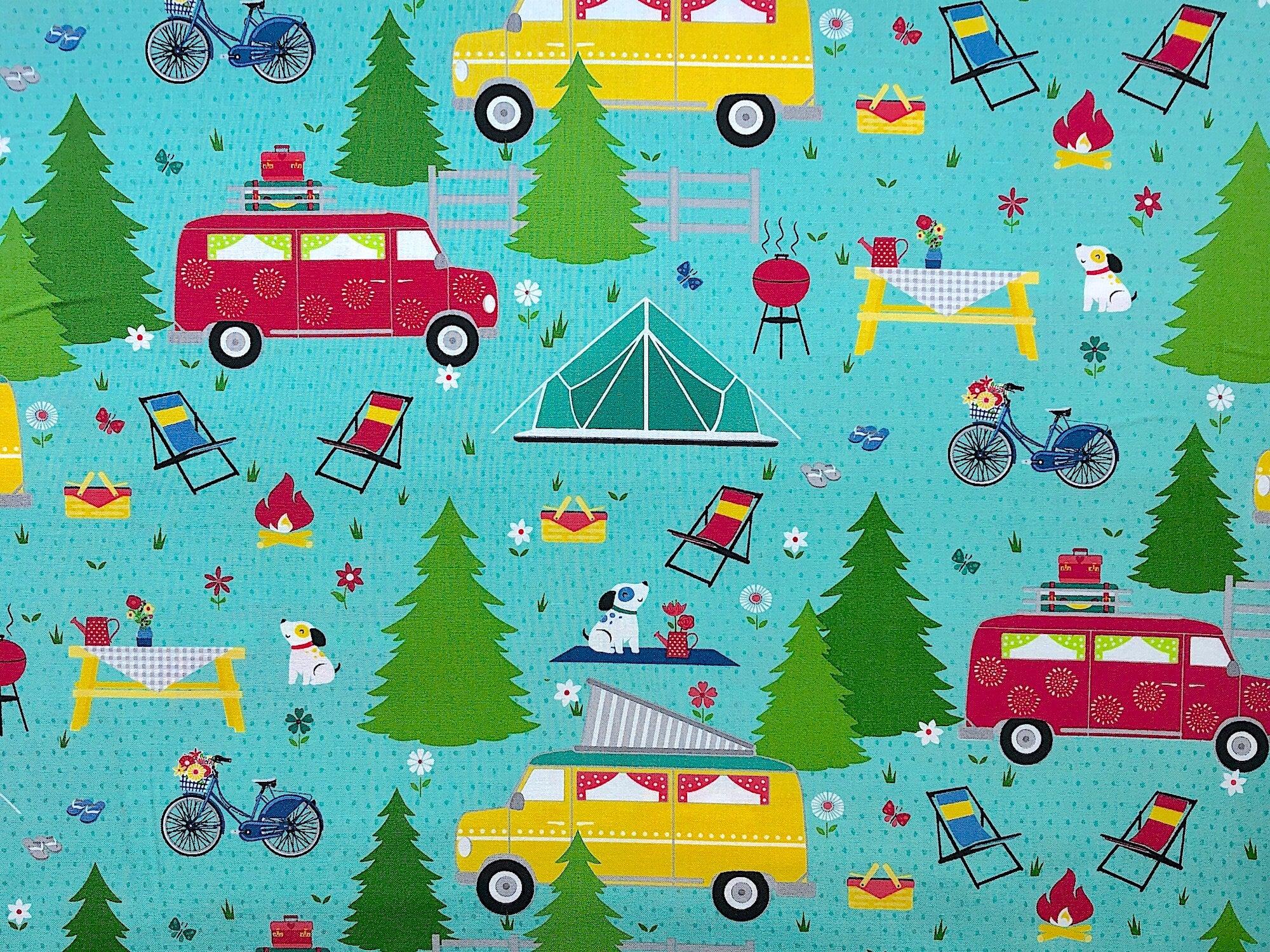 This fabric is called Adventure Time. The teal colored fabric is covered with red and yellow camping vans, trees, dogs, grills, picnic tables and more.