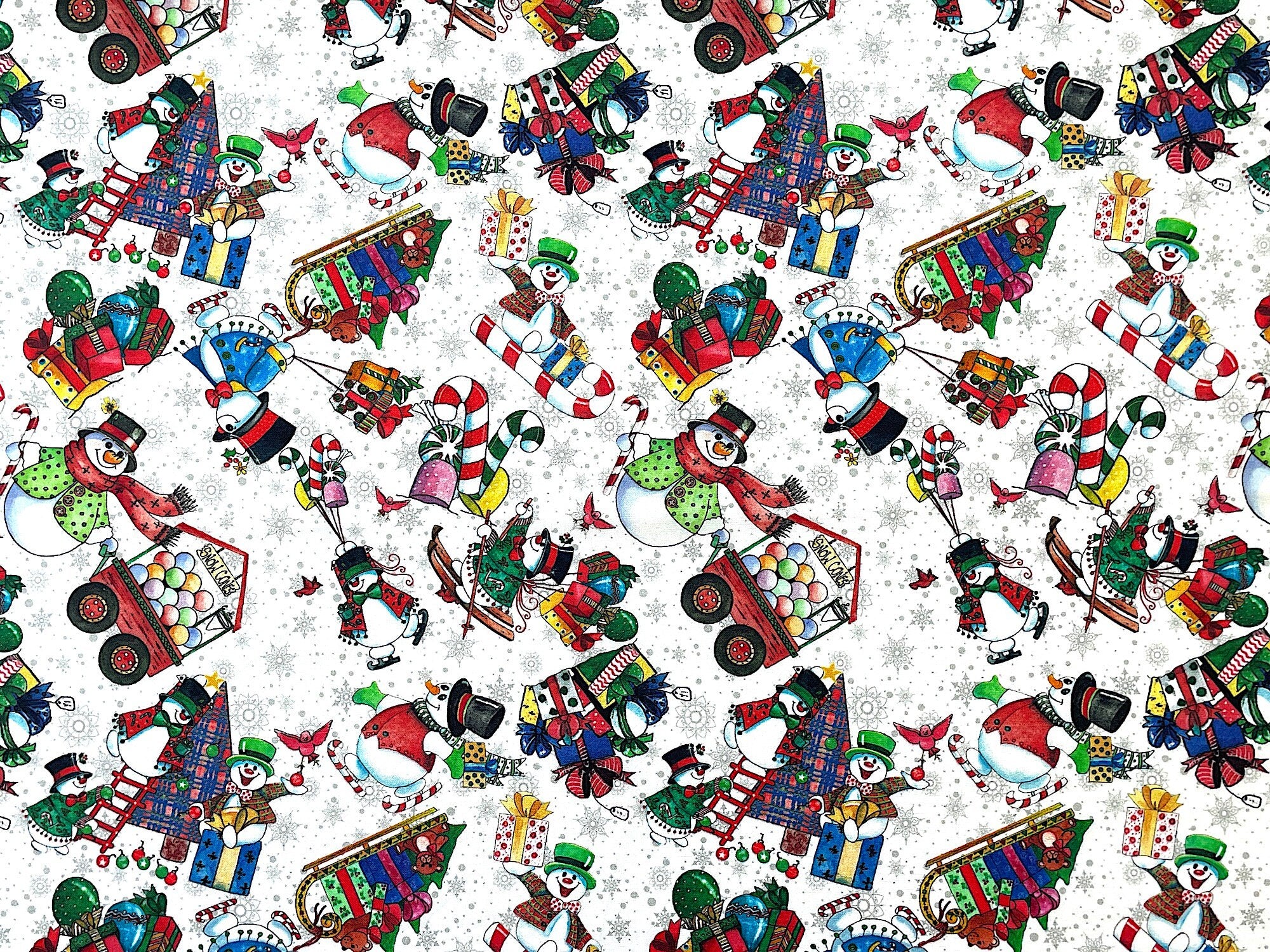This fabric is part of the Snowman Follies collection. This white fabric is covered with snowmen, trees, presents, candy canes and more. Some of the snowmen are decorating trees, pulling sleds, walking in candy cane skis and more