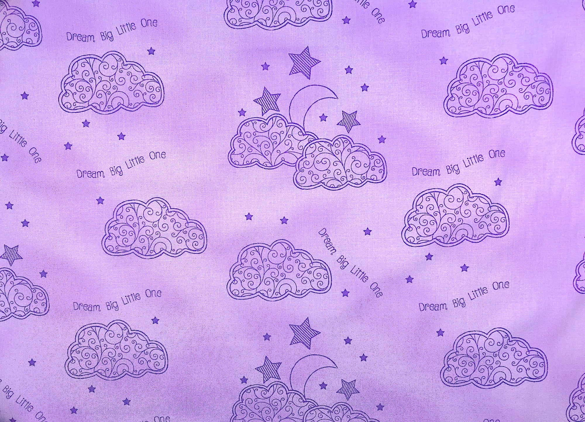 Light lavender fabric covered with clouds, moons and stars.