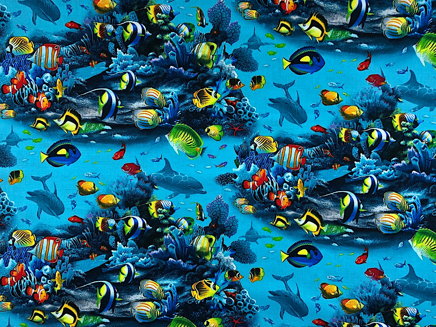 Blue cotton fabric covered with saltwater fish.