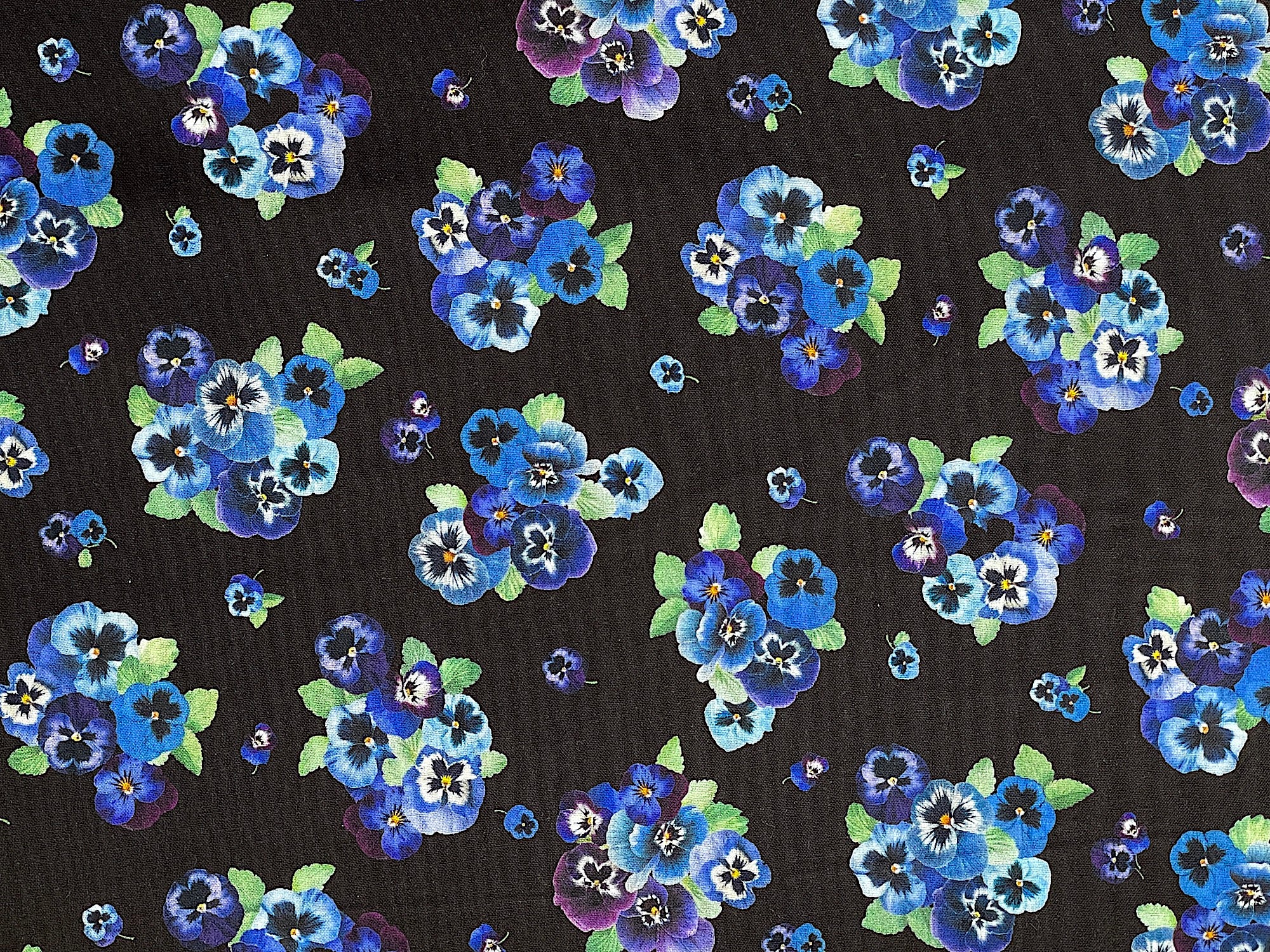 Cotton fabric covered with pansies.