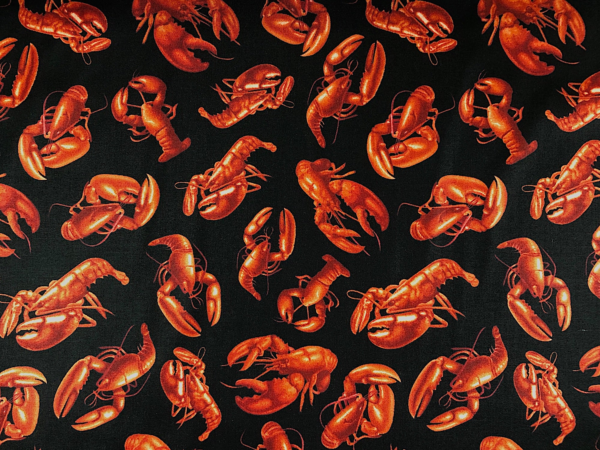Black cotton fabric covered with red lobsters.