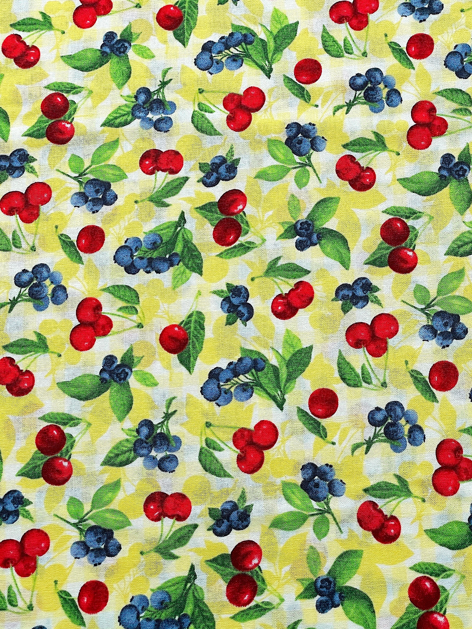 This fabric is part of the Ambrosia Farm collection.&nbsp; This yellow fabric is covered with cherries and blueberries.