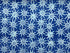 This blue Batik fabric is covered with light blue suns.