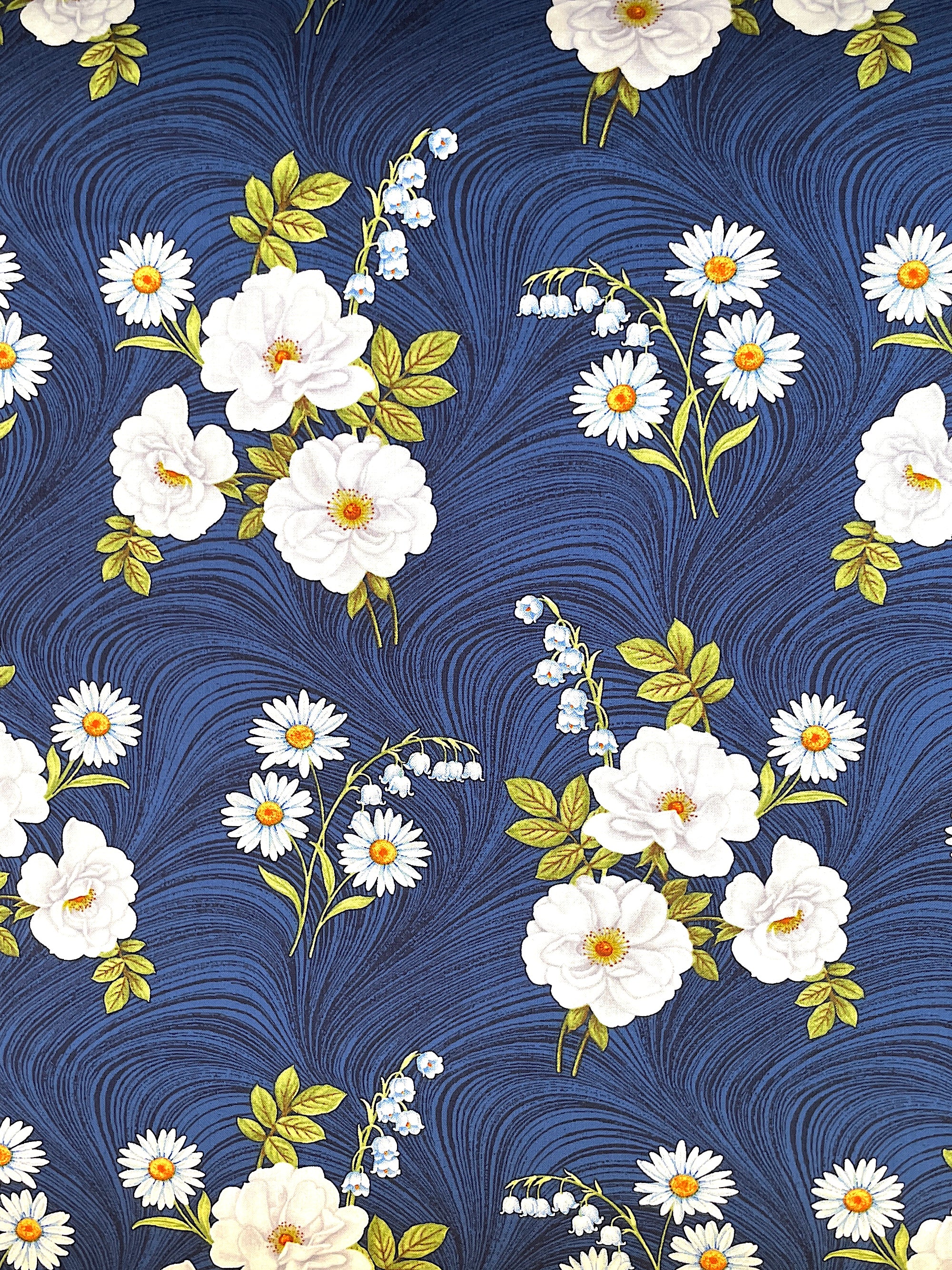 This fabric is from the Blue &amp; White Elegance collection. This dark blue cotton fabric is covered with white flowers and green leaves.