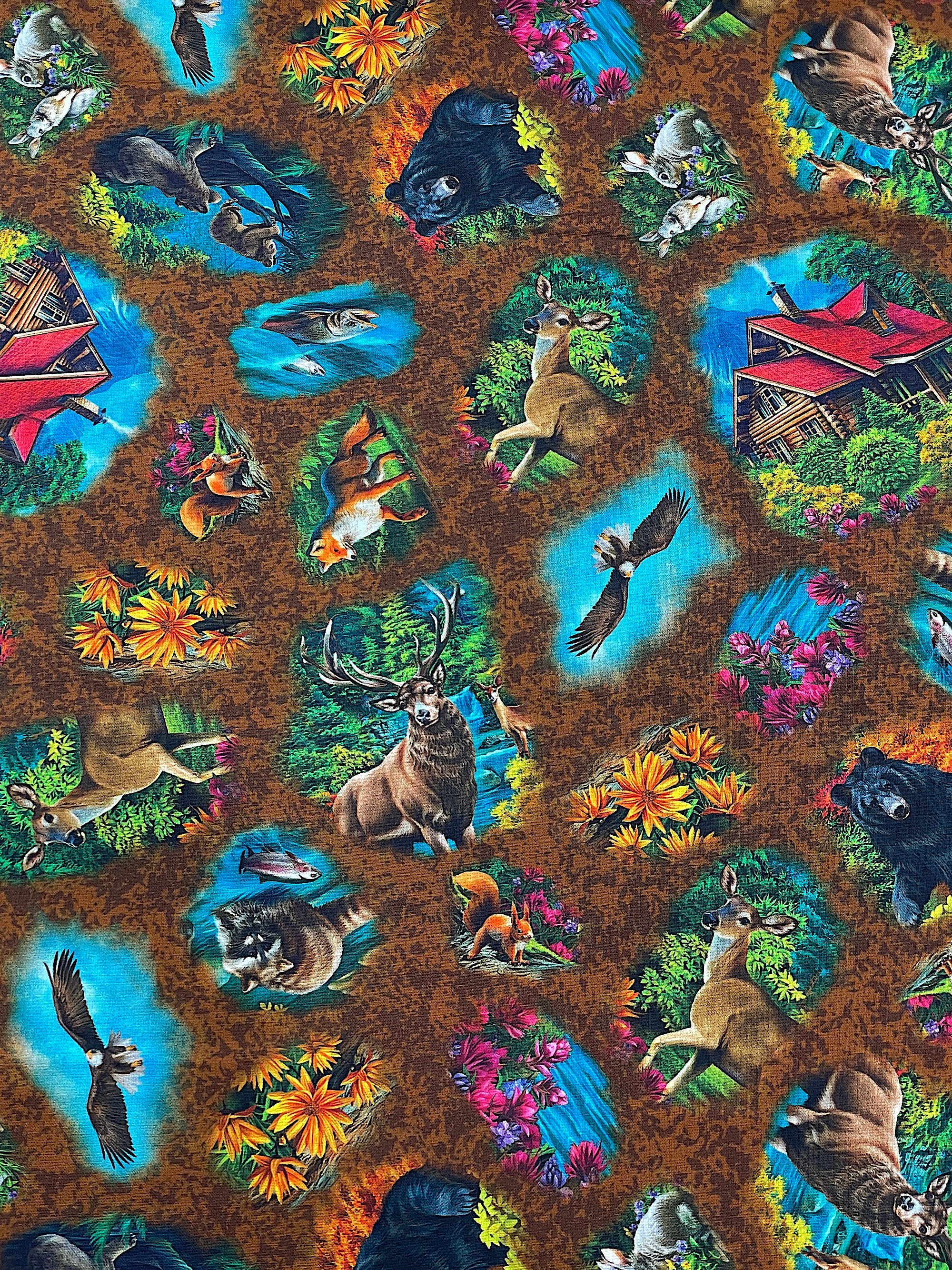 This fabric is called Brookside Lodge Animal Vignettes. This brown cotton fabric is covered with cabins, beer, deer, flowers, birds and more.