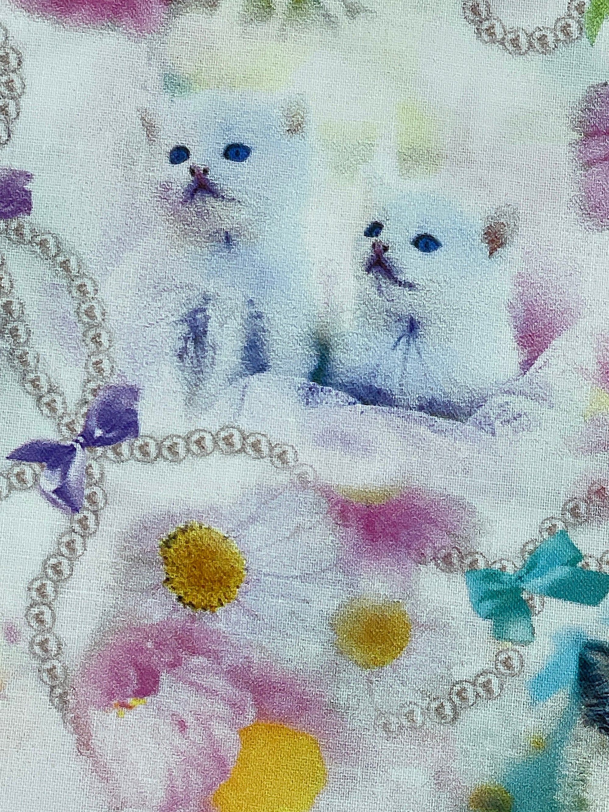 Two kittens within the flowers.
