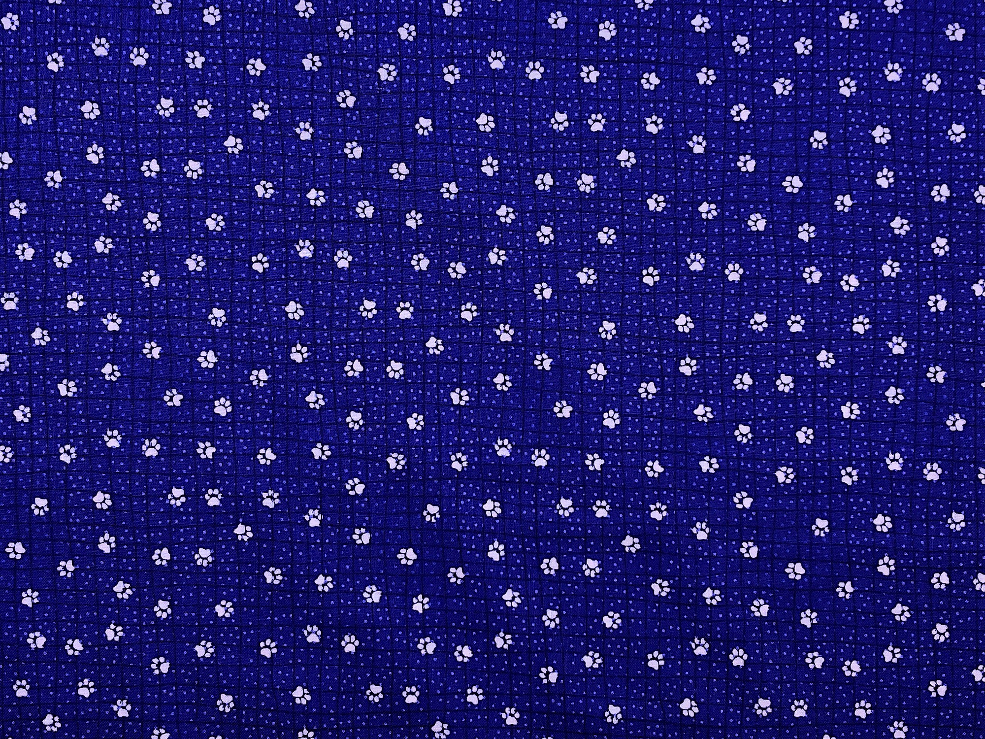This blue fabric is covered with white paw prints.