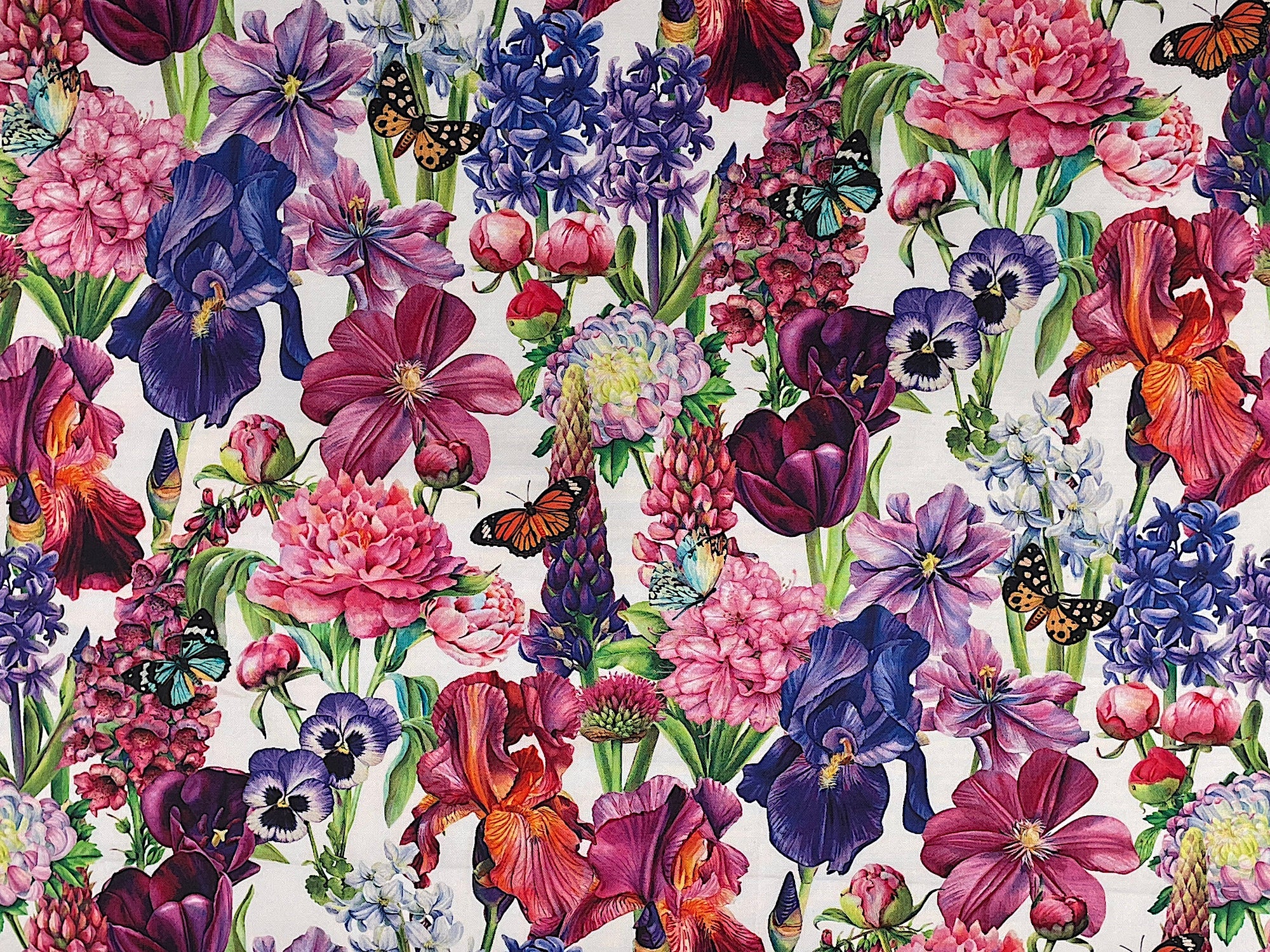 From Northcott Fabrics this white&nbsp; fabric is covered with snapdragons, iris, peonies, tulips and other flowers.&nbsp; There are also butterflies throughout the fabric. This fabric is part of Deborah's Garden collection by Northcott Fabrics.