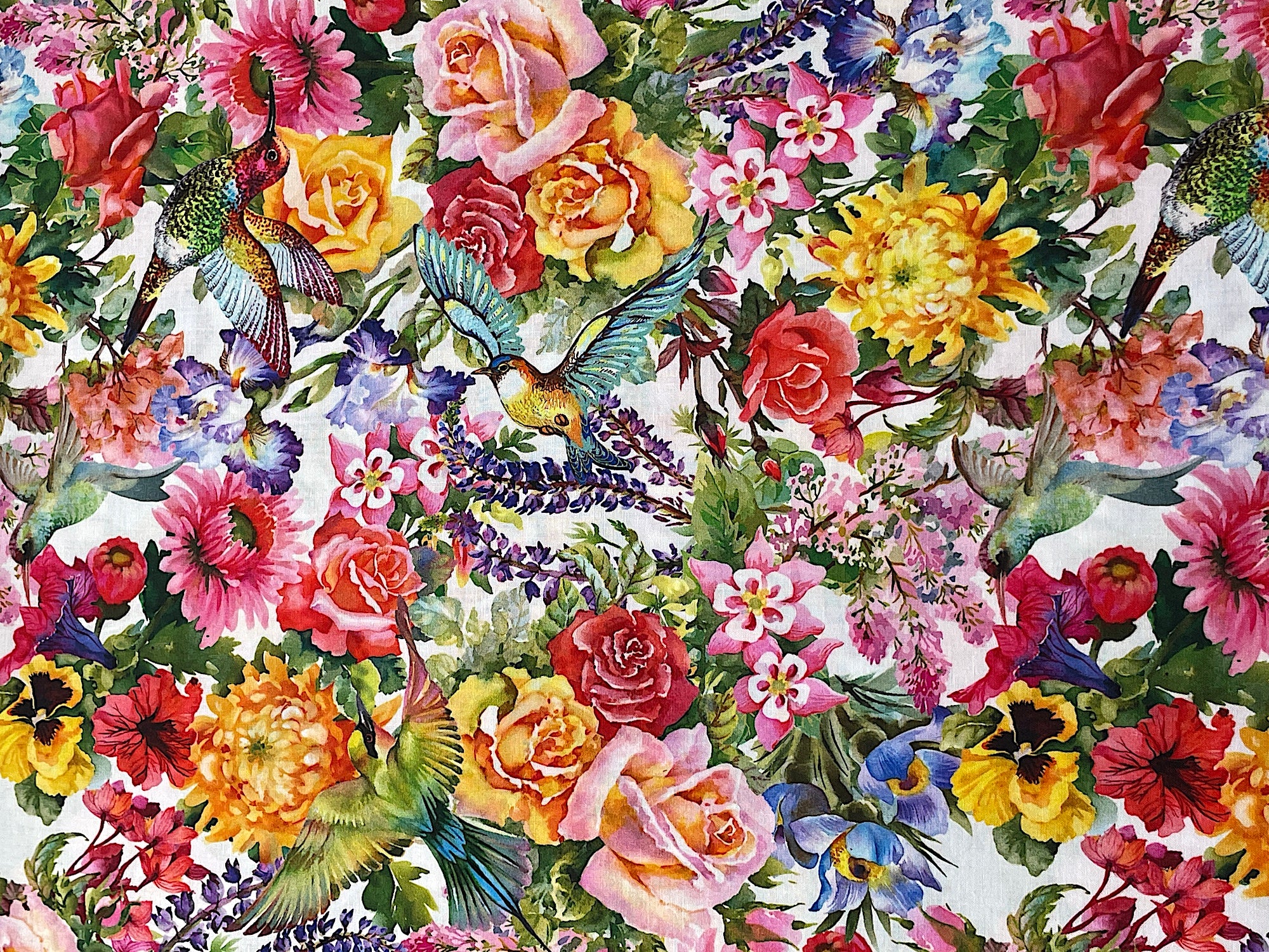 This white fabric is part of the Decoupage collection.&nbsp; This cotton fabric is covered with various flowers such as iris, roses, pansies and more.&nbsp; You will also find birds throughout the fabric.