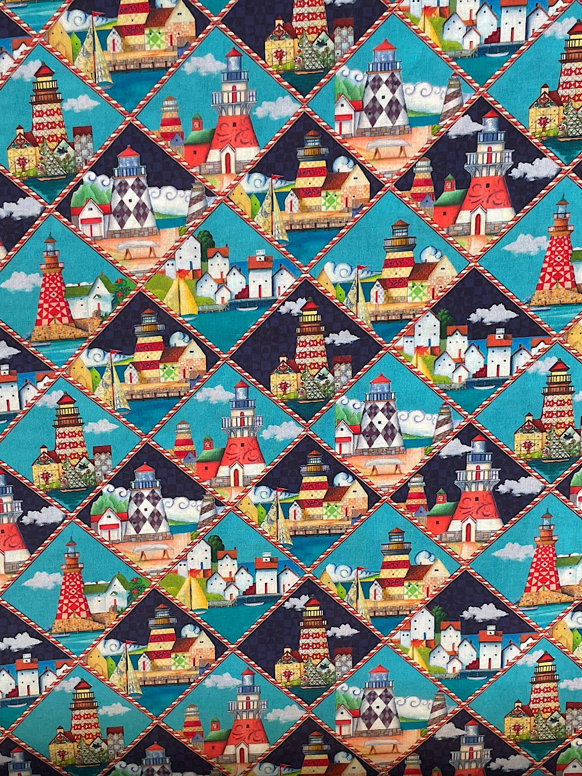 Cotton fabric covered with lighthouses that are in diamonds.