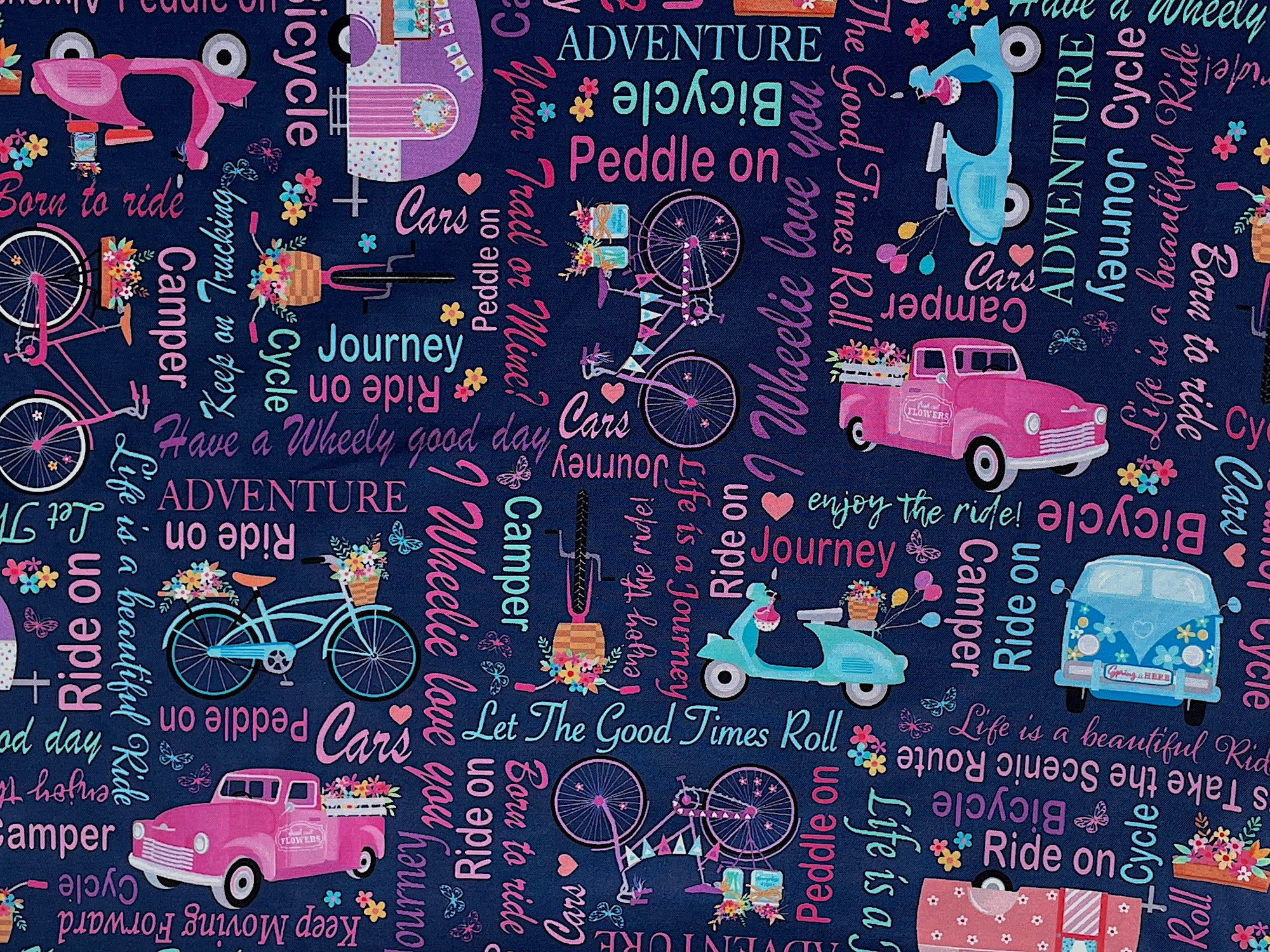 This blue cotton fabric is part of the Enjoy the Ride Collection.&nbsp; This fabric is covered with travel trailers, bicycles, scooters, trucks and words. Some of the words are, bicycle, always take the scenic route, let the good times roll, ride on, journey, peddle on, adventure, camper and more