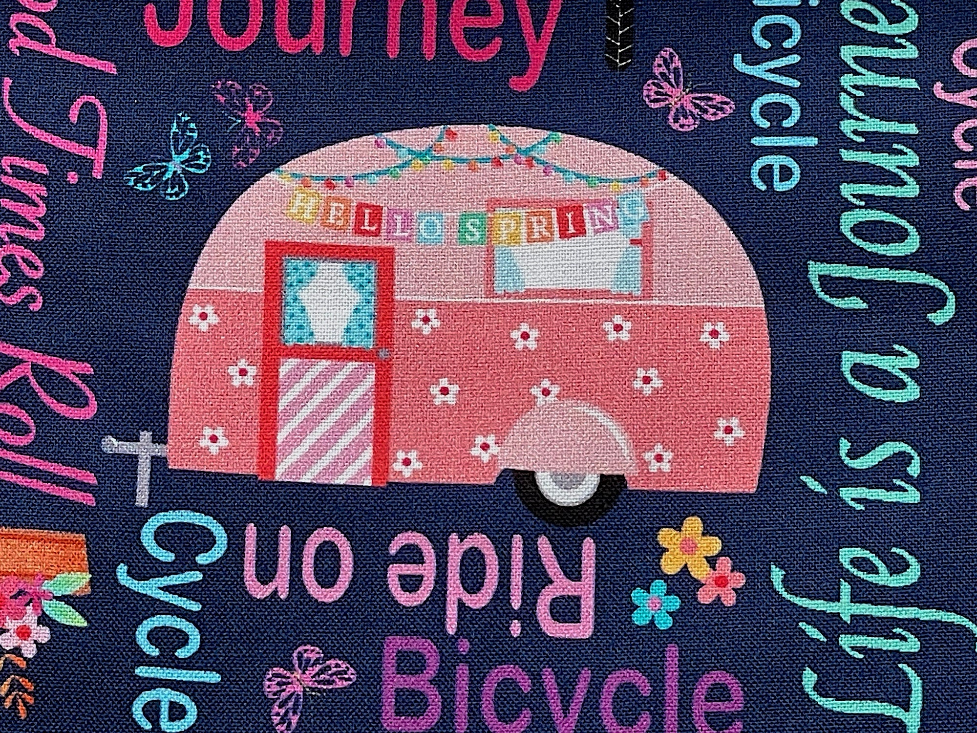 Close up of travel trailer with a hello spring banner on it.
