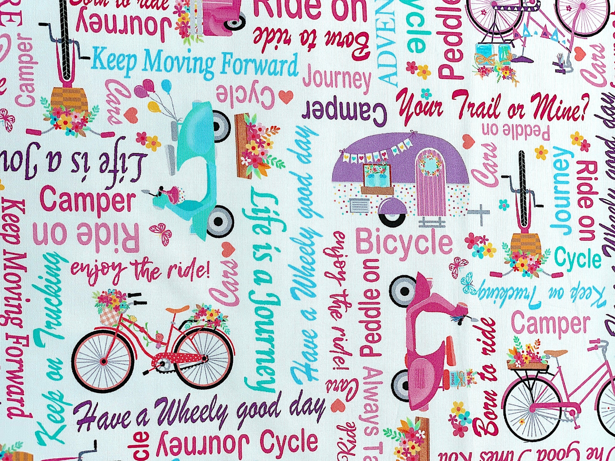 This white cotton fabric is part of the Enjoy the Ride Collection.&nbsp; This fabric is covered with travel trailers, bicycles, scooters, trucks and words. Some of the words are, bicycle, always take the scenic route, let the good times roll, ride on, journey, peddle on, adventure, camper and more