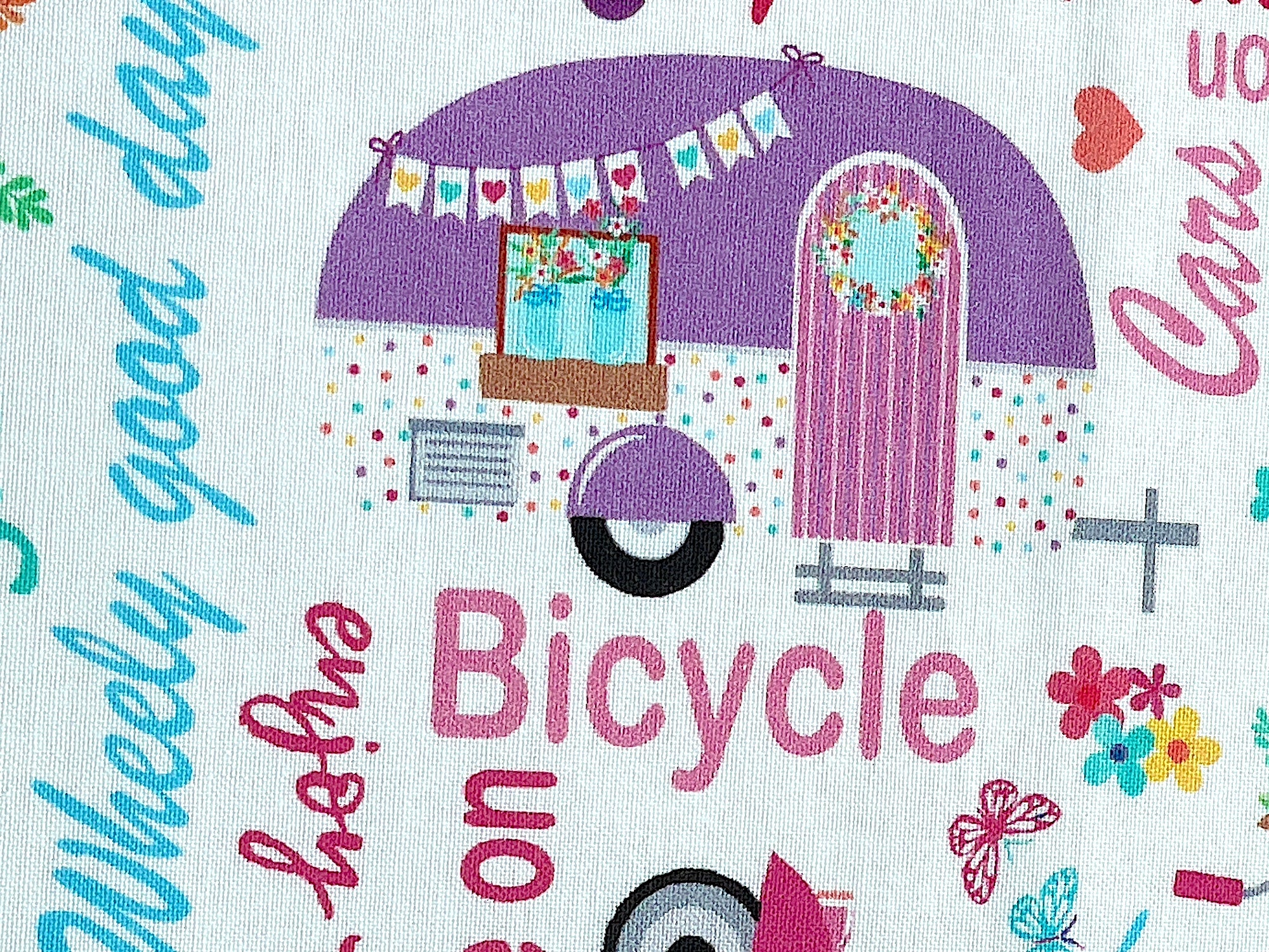 Close up of a purple and white travel trailer.