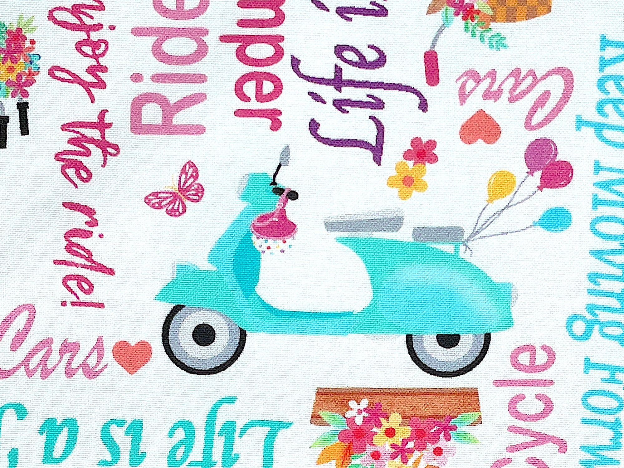 Close up of a scooter with balloons.