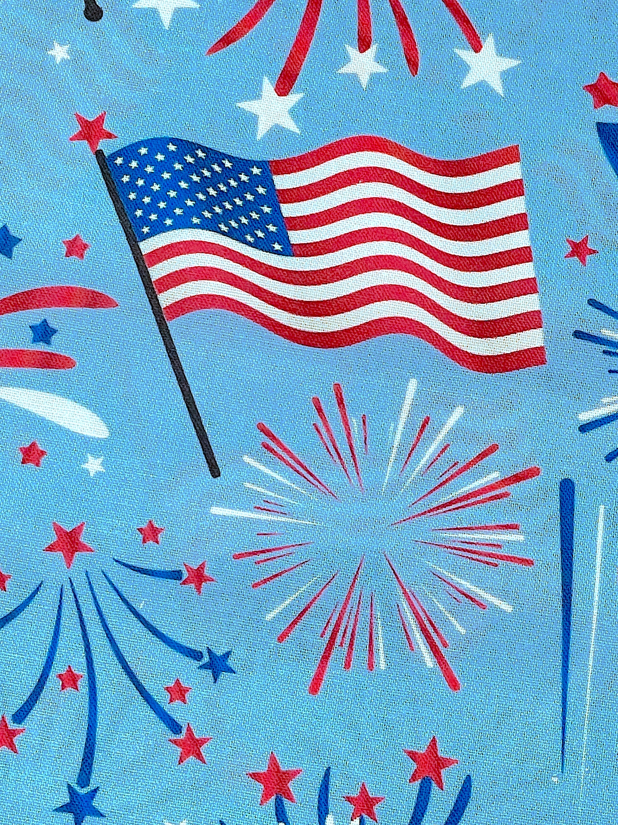 Close up of a USA flag and fireworks.