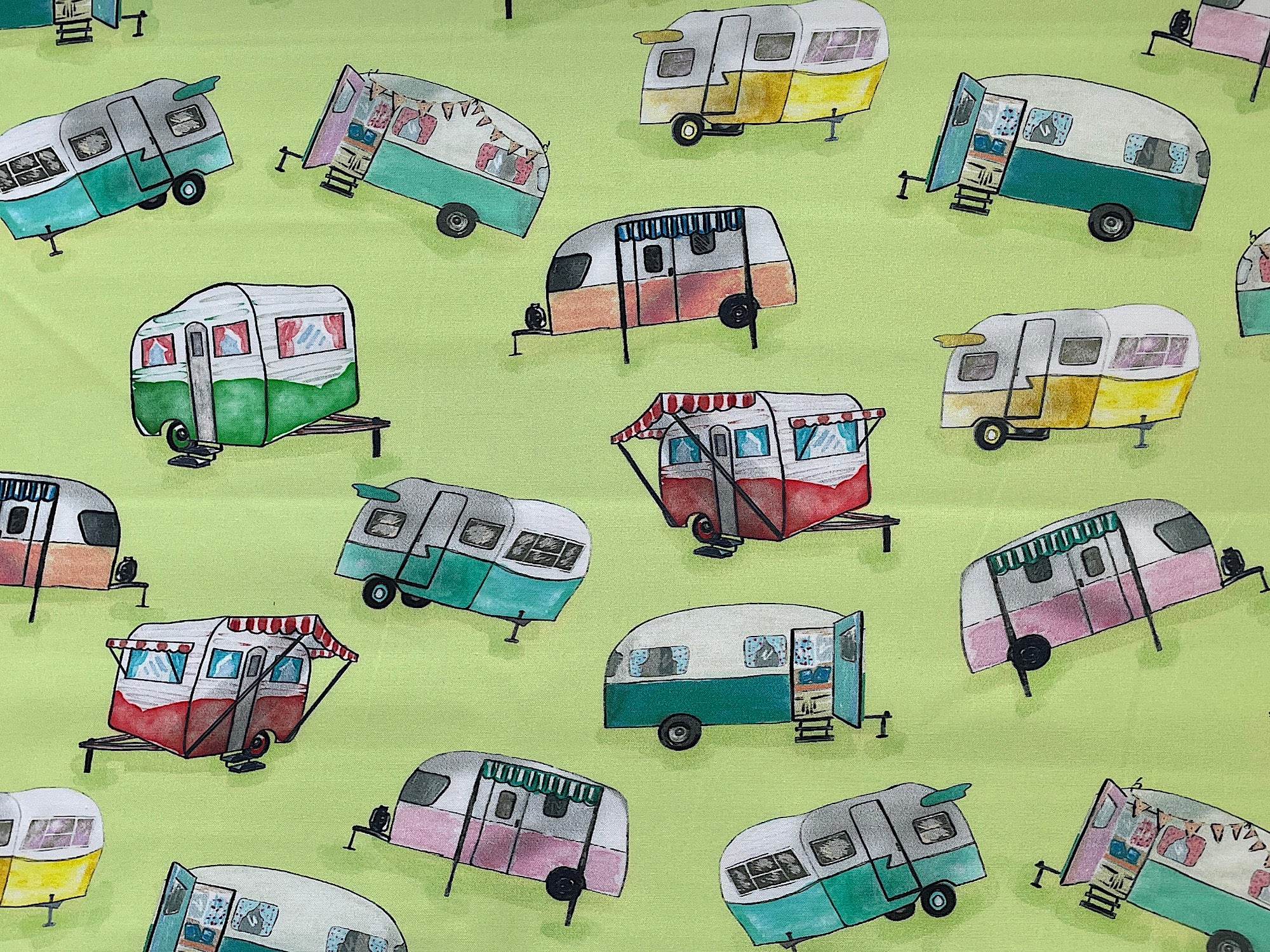 This light green fabric is covered with green, blue, yellow, pink and white travel trailers.