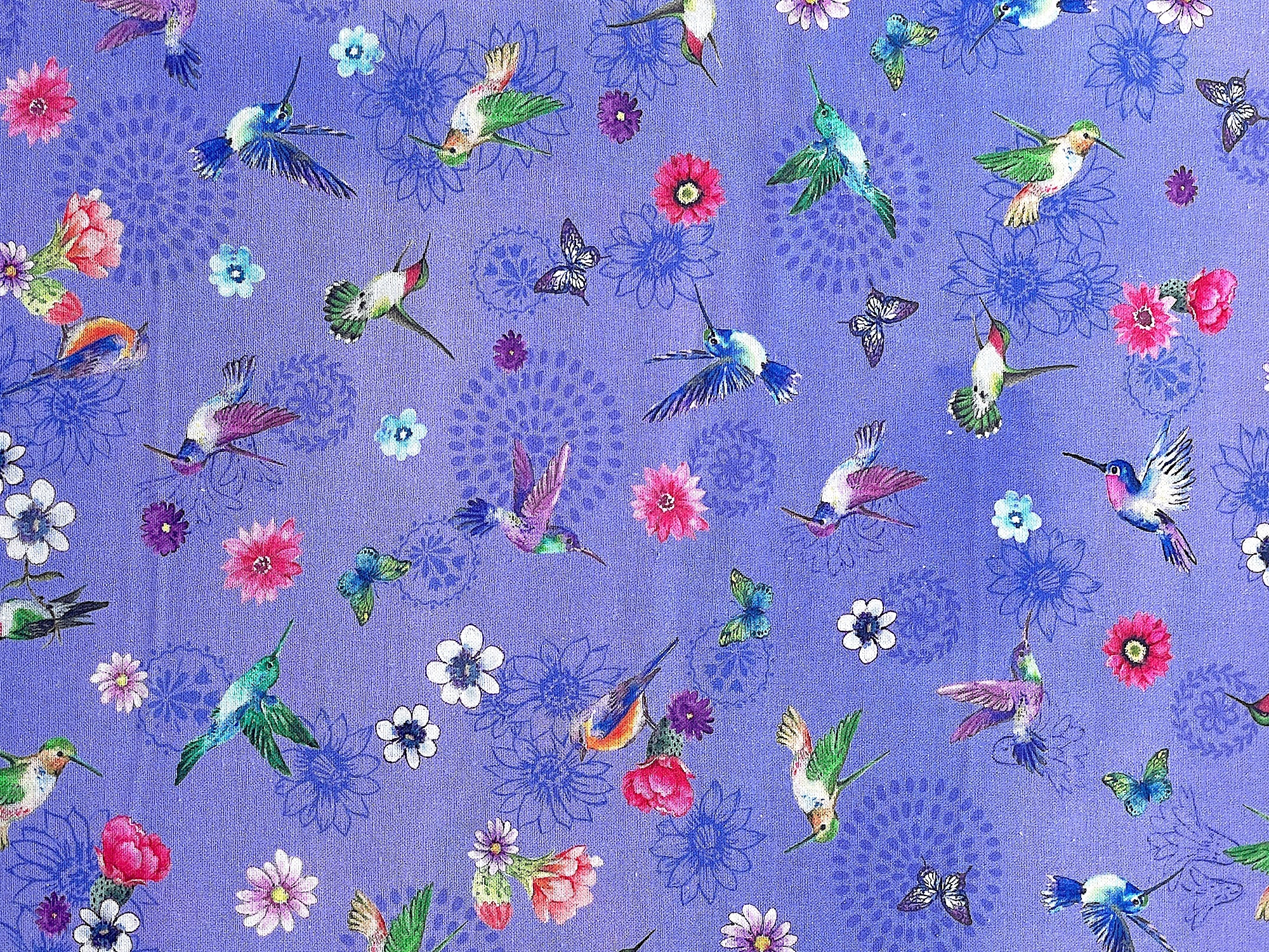This purple cotton fabric is covered with hummingbirds, flowers, birds&nbsp; and butterflies.&nbsp;