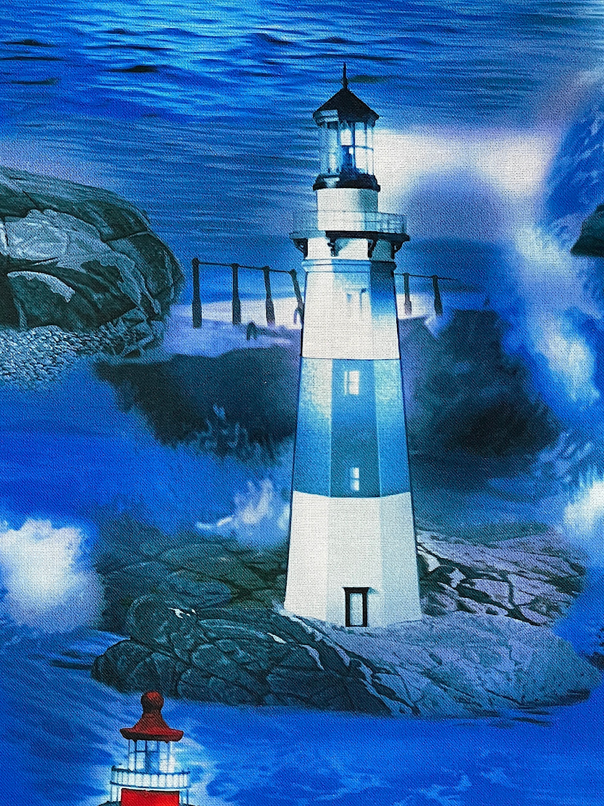 Close up a blue and white lighthouse surrounded by rock then water.
