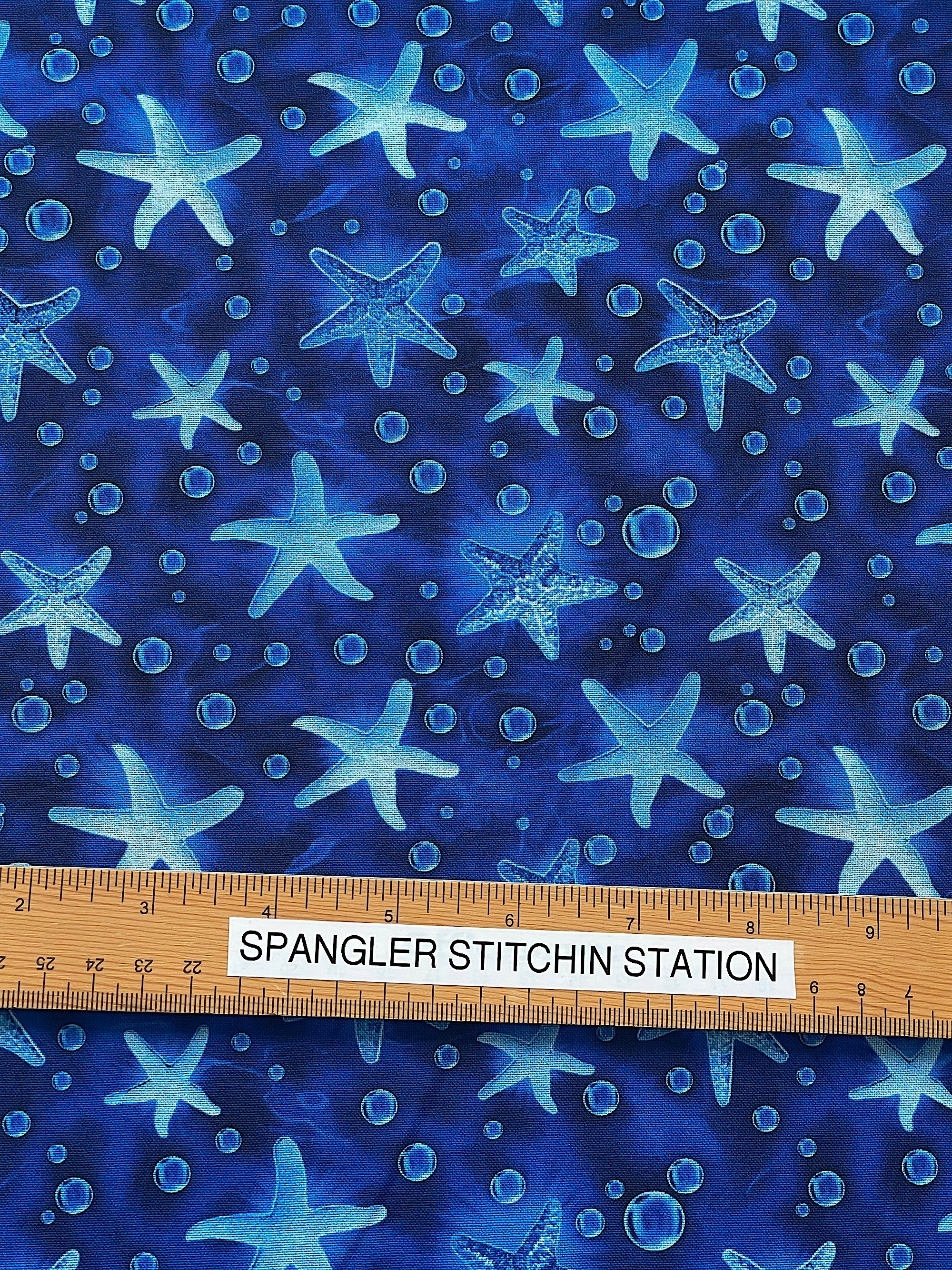 Ruler on fabric to show the size of the starfish.