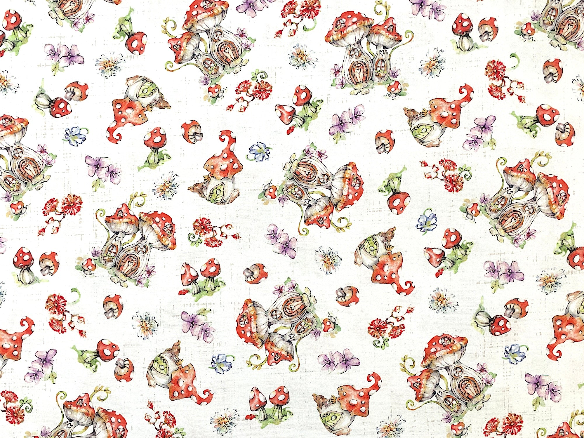 White cotton fabric covered with mushrooms, mushroom houses and flowers.