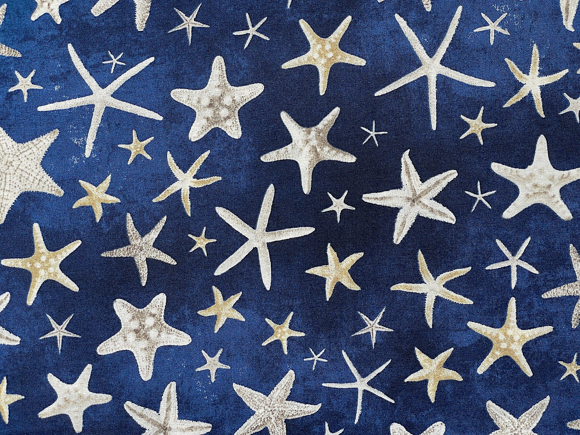 Navy cotton fabric covered with starfish