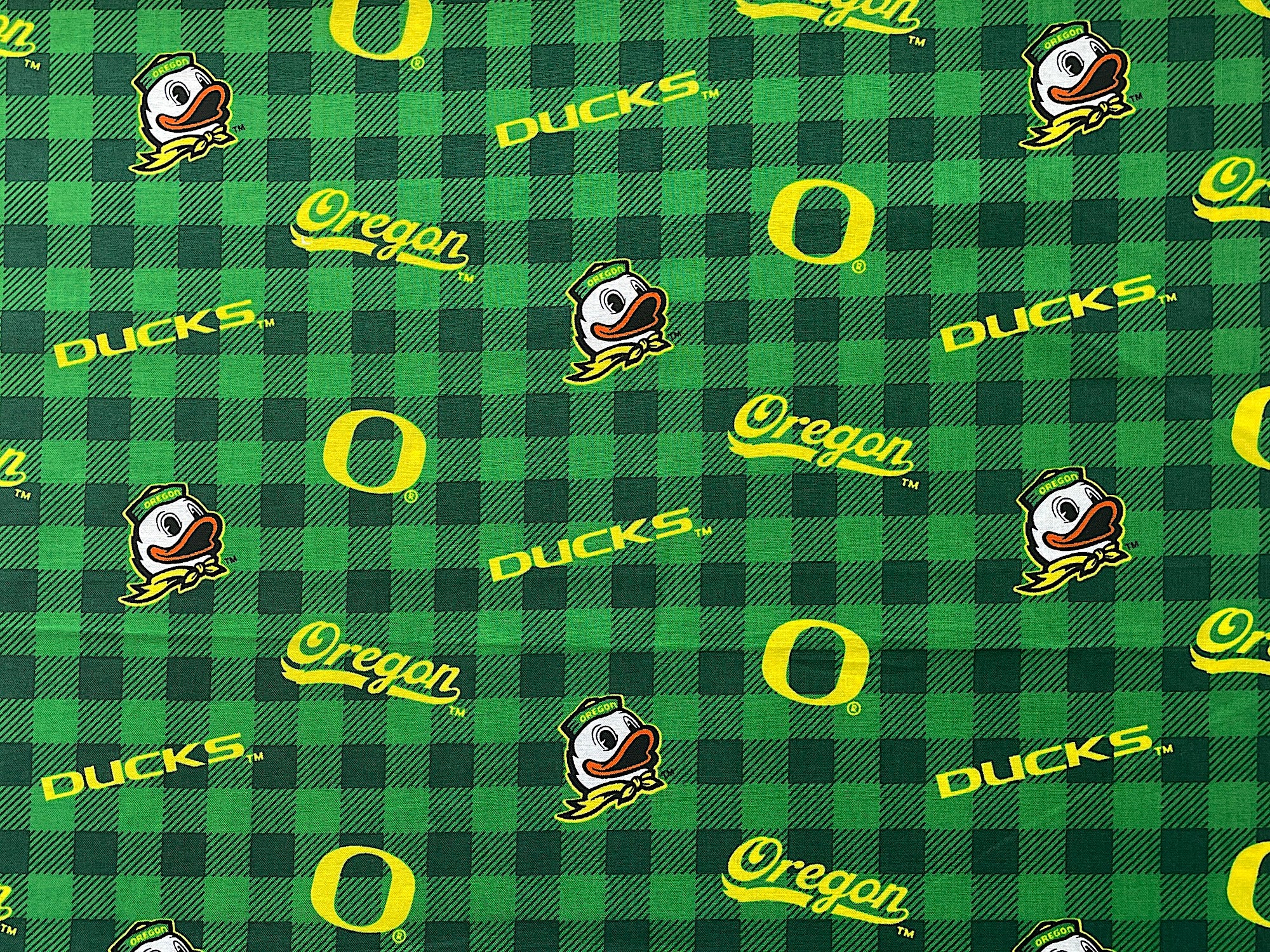Plaid green fabric covered with Oregon ducks.