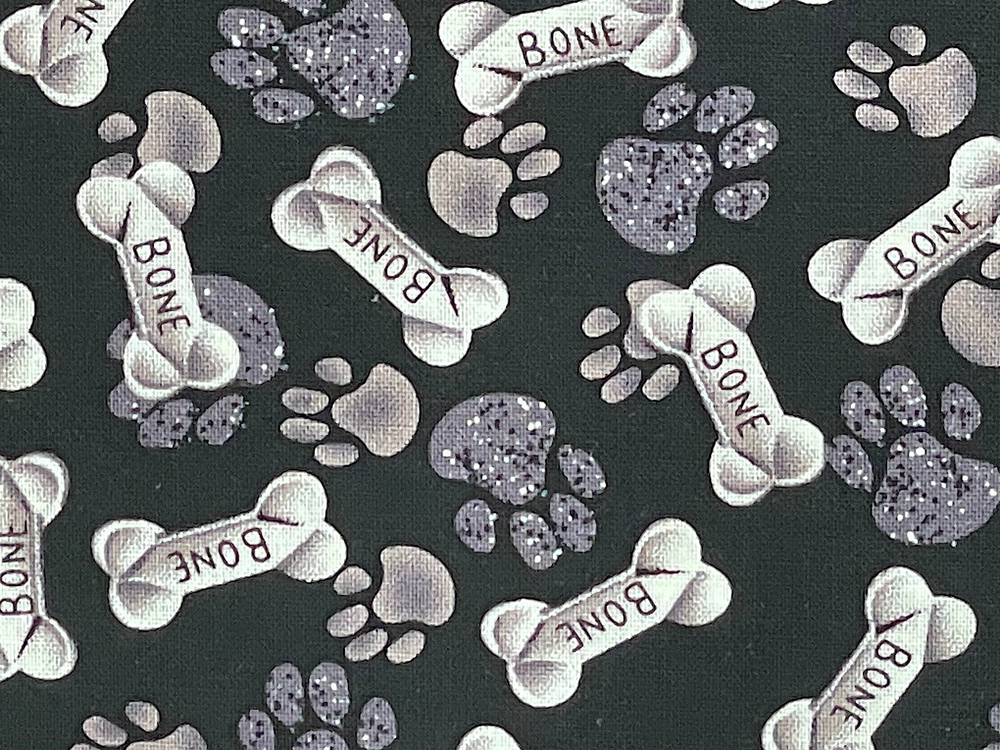Close up of dog bones and paw prints.