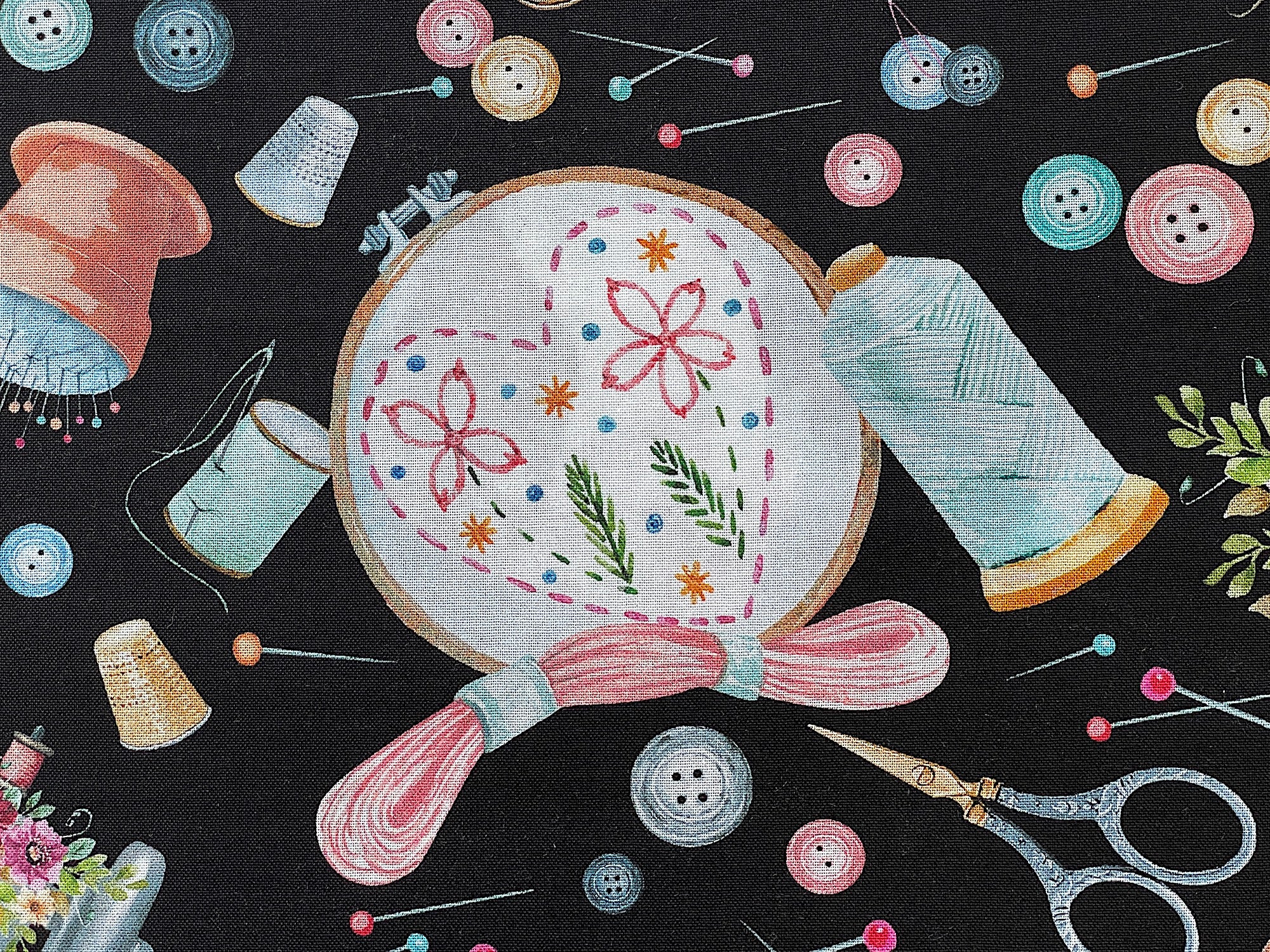 Close up of a completed hand embroidery project, scissors, buttons and more.