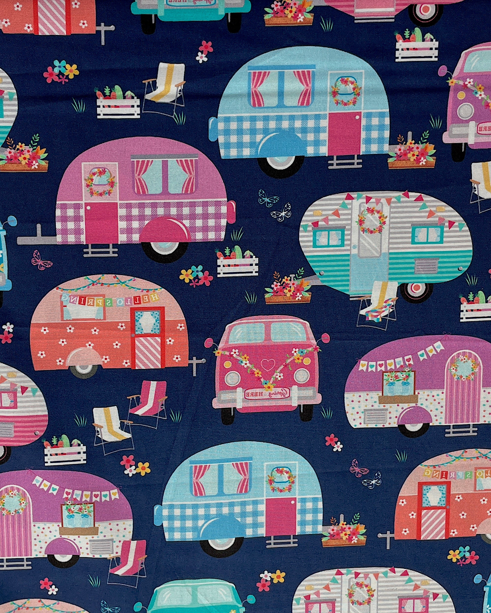 This blue cotton fabric is part of the Enjoy the Ride Collection.&nbsp; This fabric is covered with travel trailers, flowers, butterflies and lawn chairs.&nbsp;