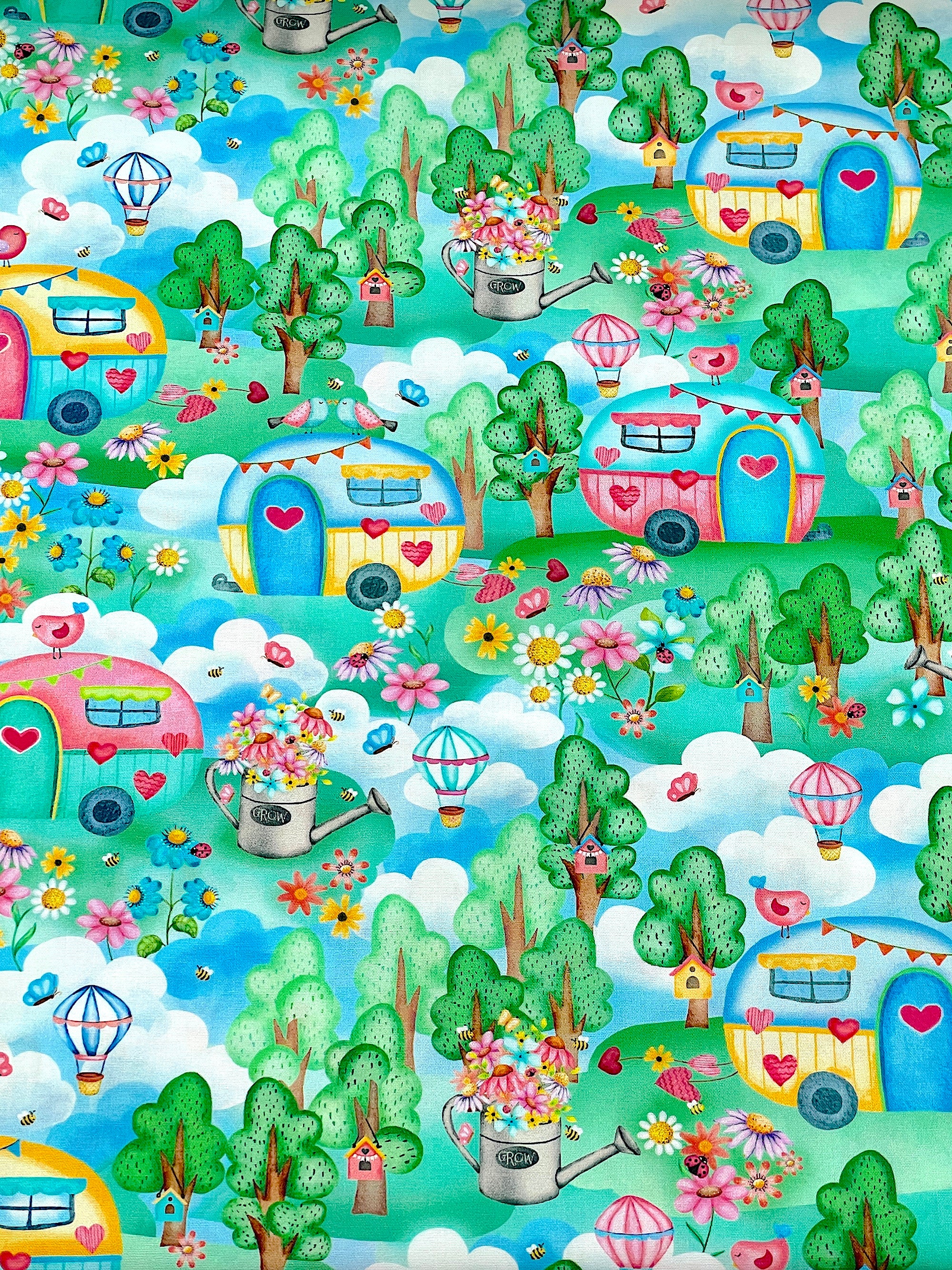 This fabric is part of the Sunshine Days collection by Nicole Decamp.&nbsp; This cotton fabric is covered with clouds, trees, watering cans, flowers, bird houses, birds and more.