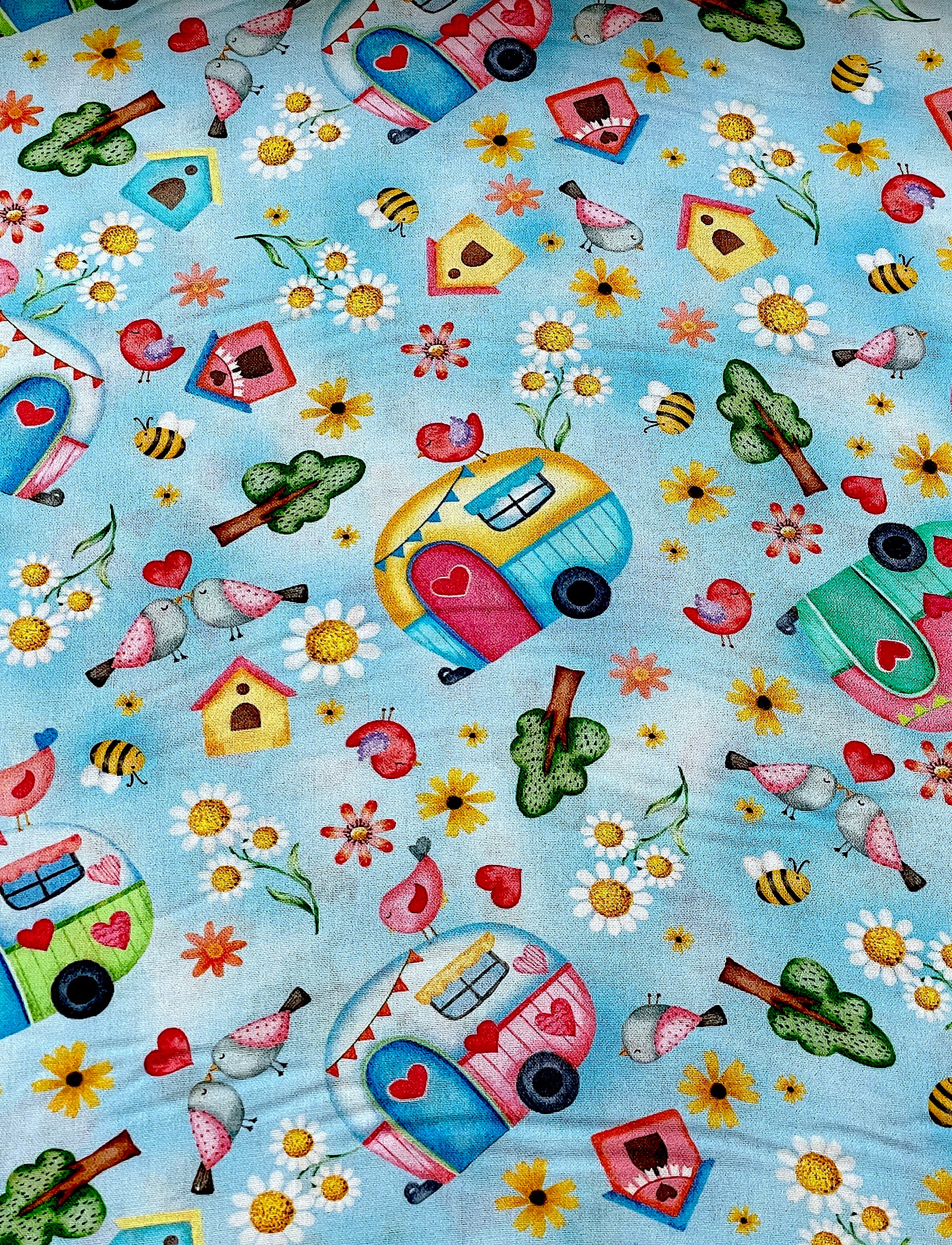 This fabric is part of the Sunshine Days collection by Nicole Decamp.&nbsp; This light blue fabric is covered with travel trailers, bird houses, trees, birds, trees and more.