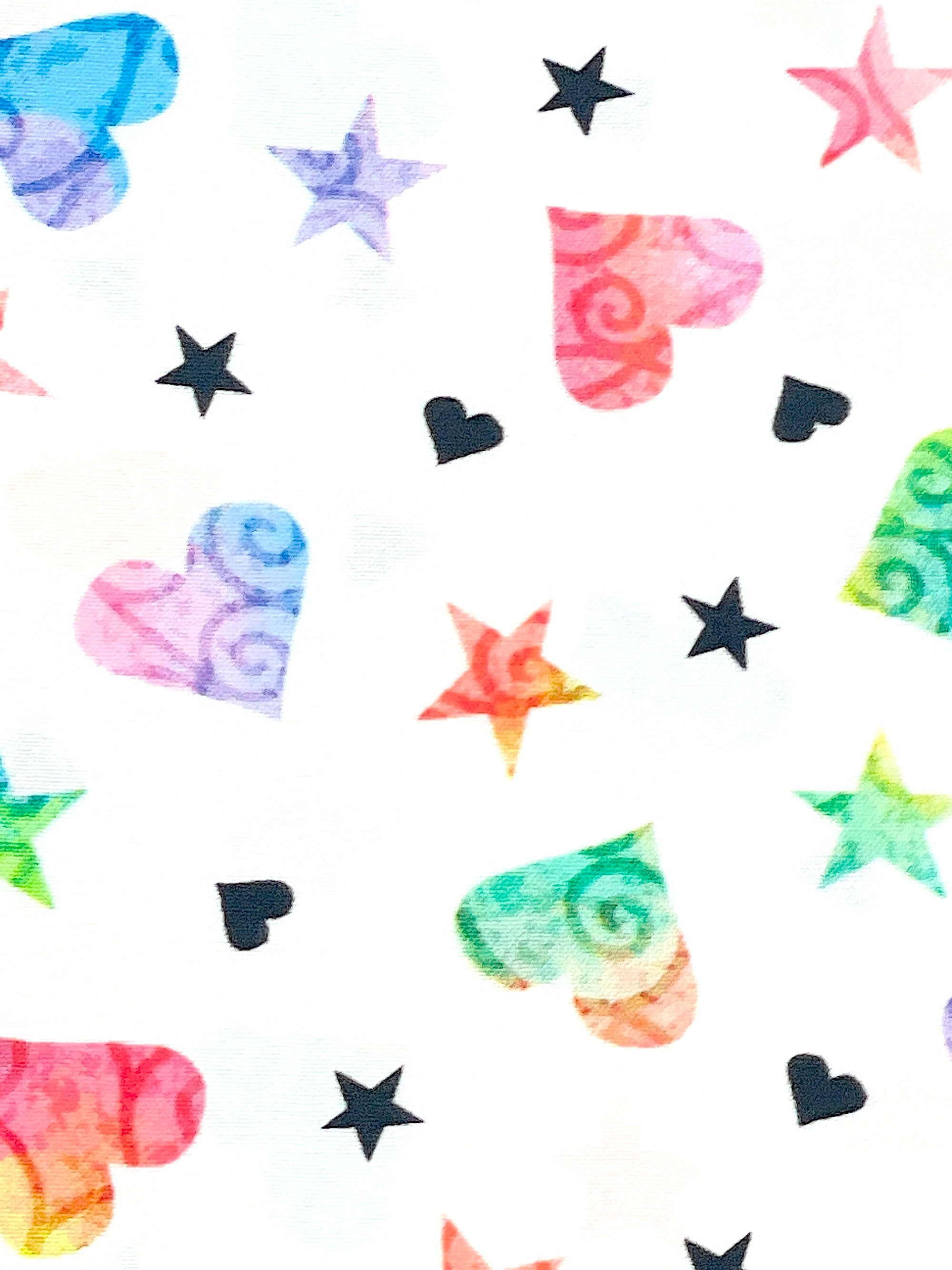 This fabric is called Be the change hearts and stars.  This white cotton fabric is covered with colorful stars and hearts.  There are purple, blue, red, yellow and green hearts and stars along with some black hearts and stars throughout the fabric.