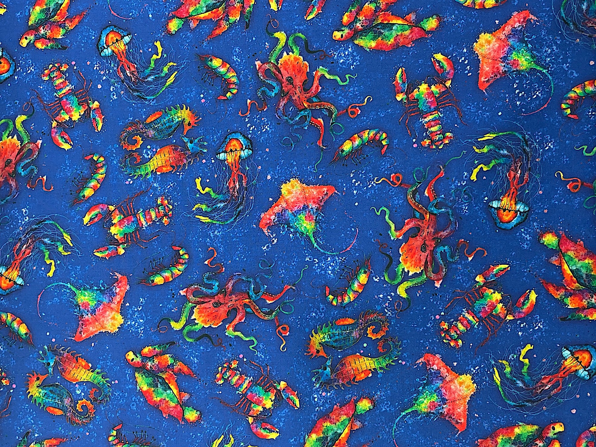This blue fabric is part of the Deep Sea collection and is covered with lobster, octopus, seahorse and more.