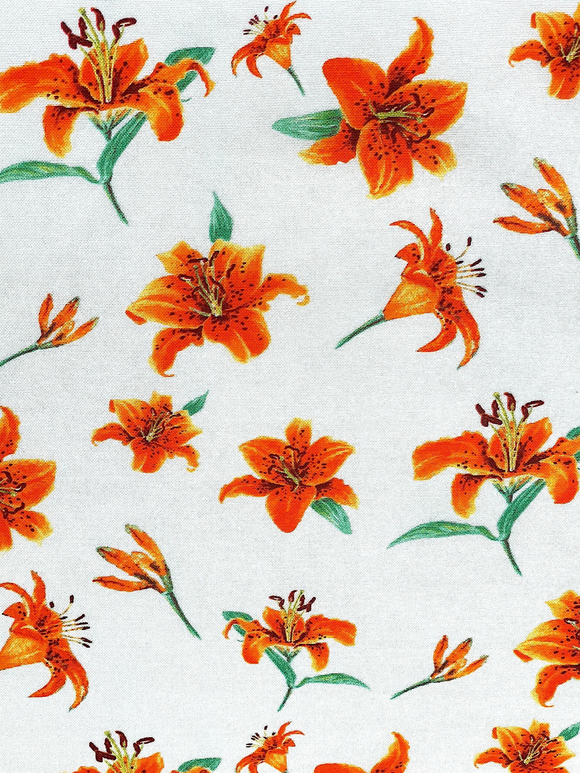 This white cotton fabric is covered with tiger Lilies. This fabric is part of the A Painted Garden Collection by Benartex.