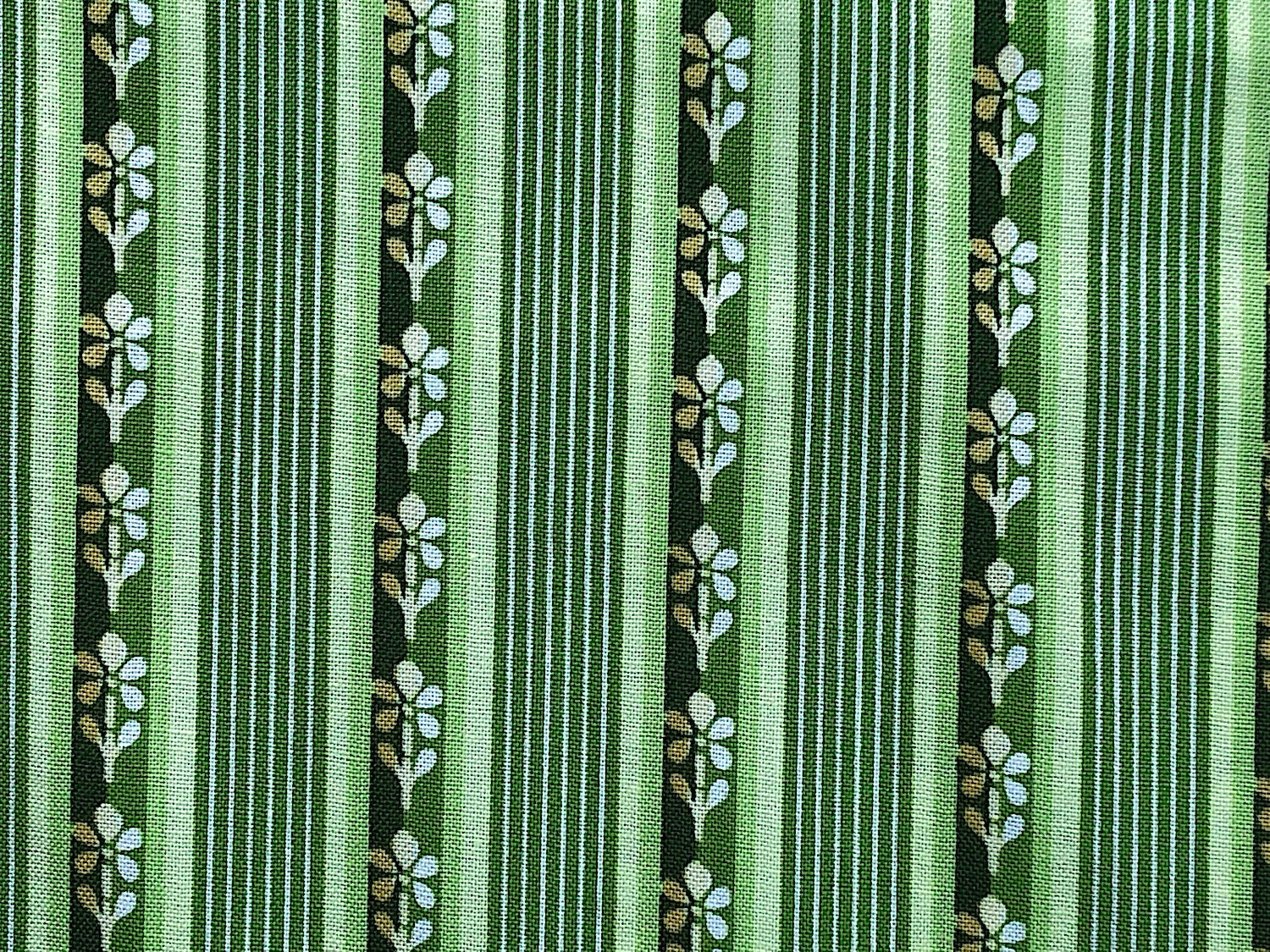 This fabric is part of the Emma's Garden collection and has green stripes with rows of flowers in some of the stripes