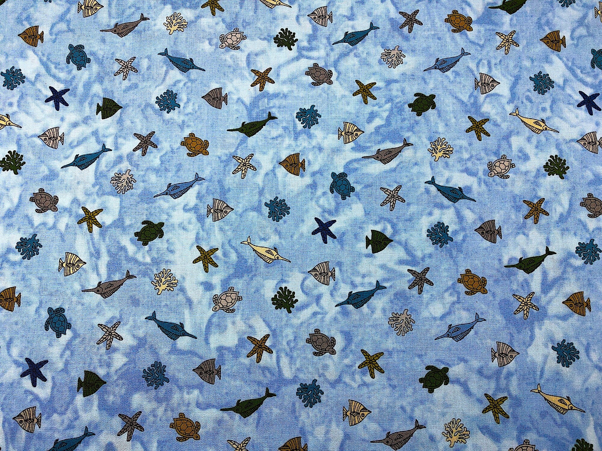 Close up of fish, starfish on a blue and white background.