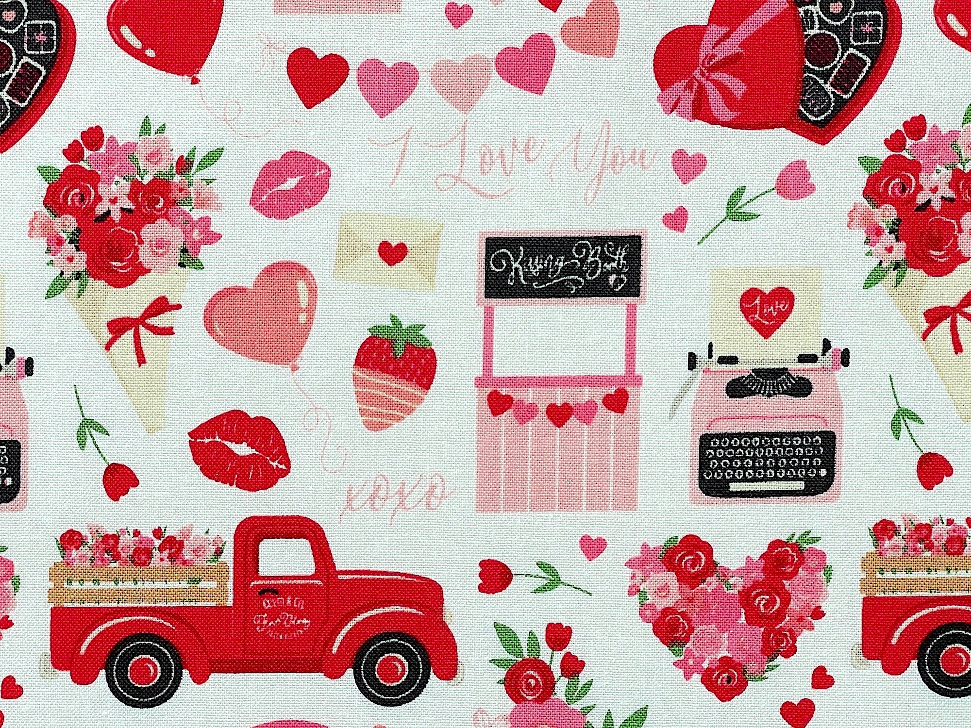 Close up of a kissing booth, red truck hearts, candy, love letters, hearts and more.