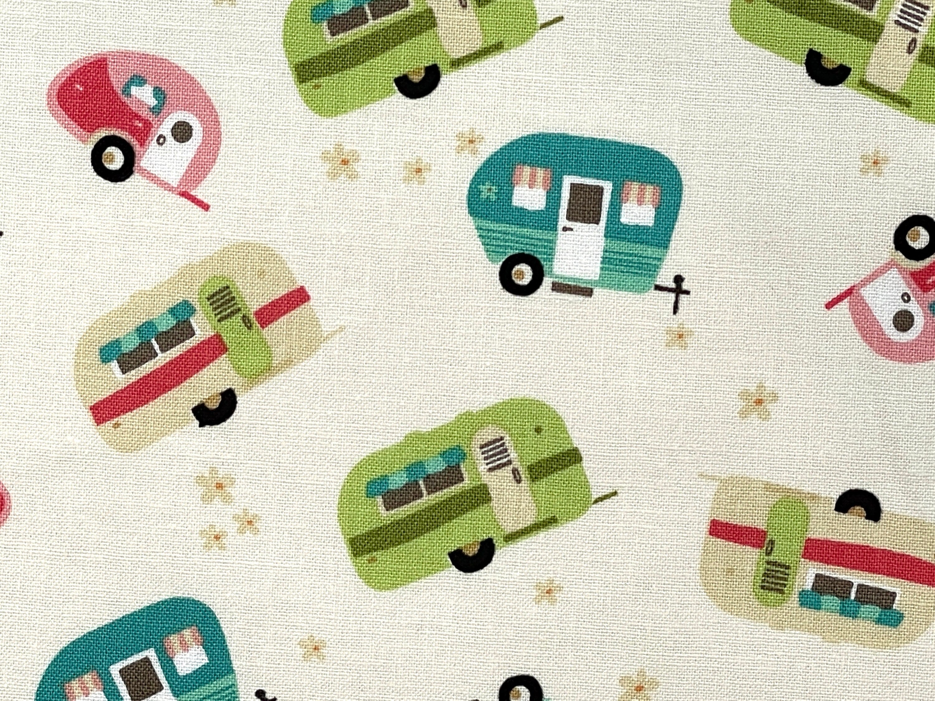 Close up of green, tan, pink travel trailer on an ivory background.