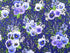 This cotton fabric is covered with bunches of pansies and other flowers and leaves. This fabric is part of the Bloomfield Avenue Collection by RJR Fabrics.