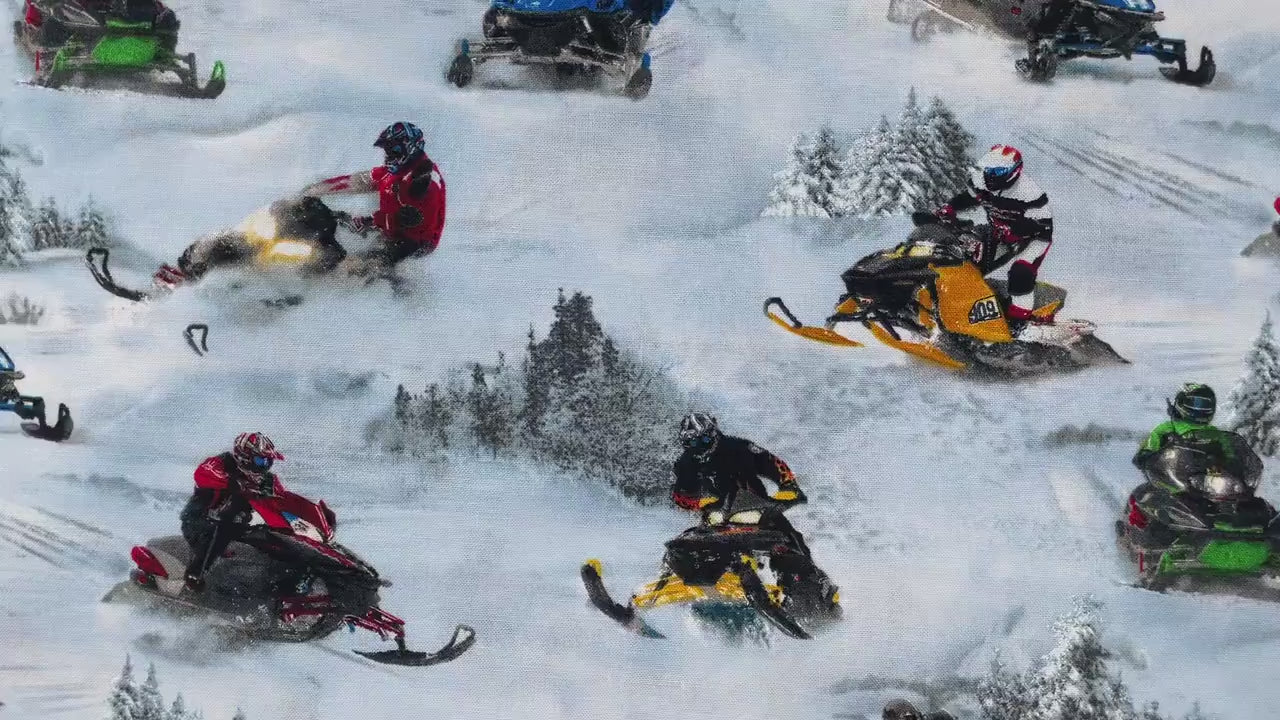 Video of fabric covered with snowmobile riders in the snow.